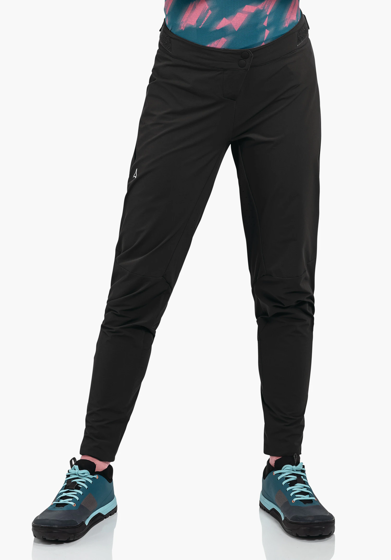 Pants Arosa L black outdoor trousers with Schöffel logo on the outer thigh, worn with legs slightly apart; paired with light blue trekking shoes and pink socks against a white background.