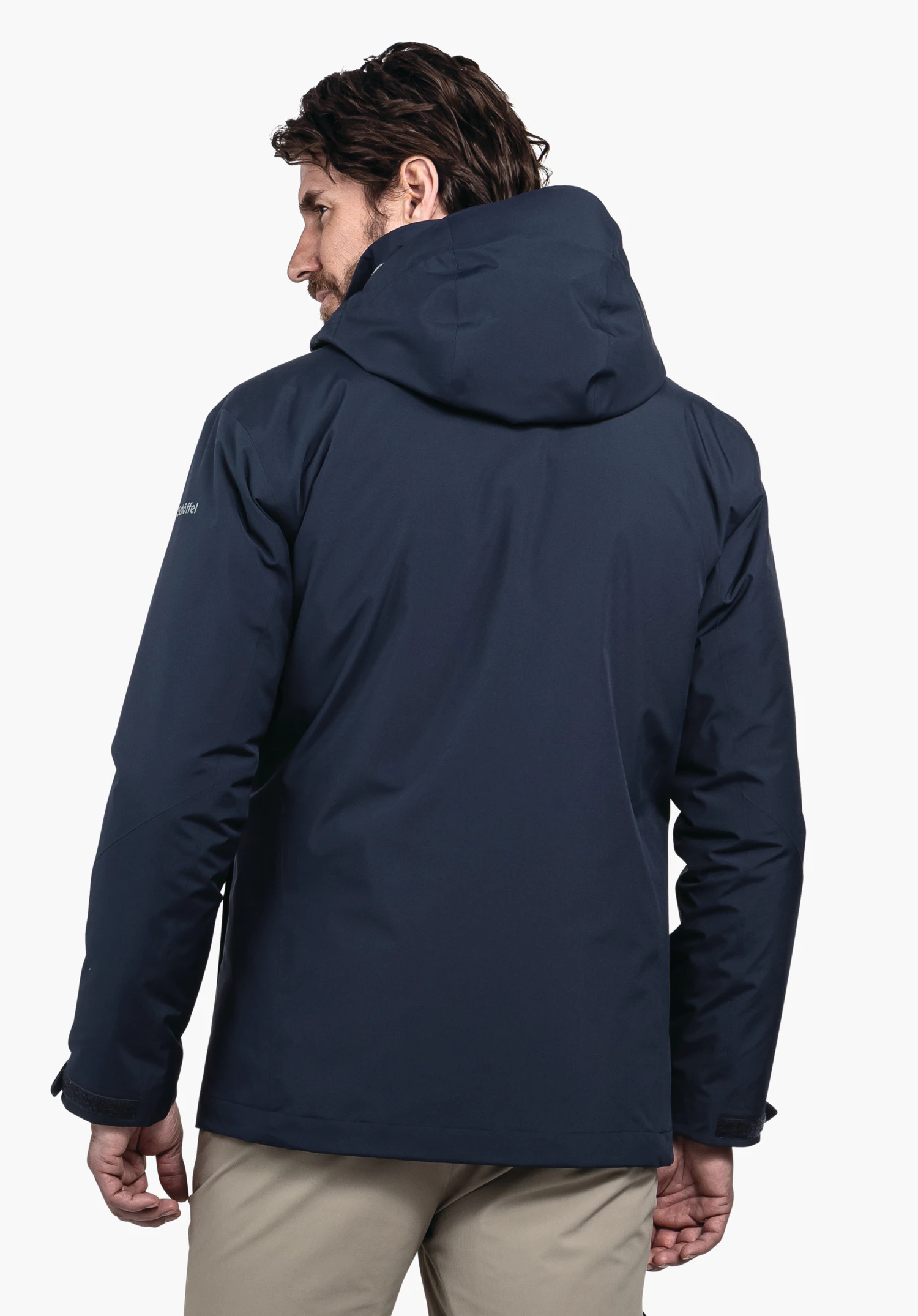 3in1 Jacket Style Tamina MNS dark blue jacket, rear view, worn by a man; hood up; neutral white background. Sleeve text: “Schöffel”.