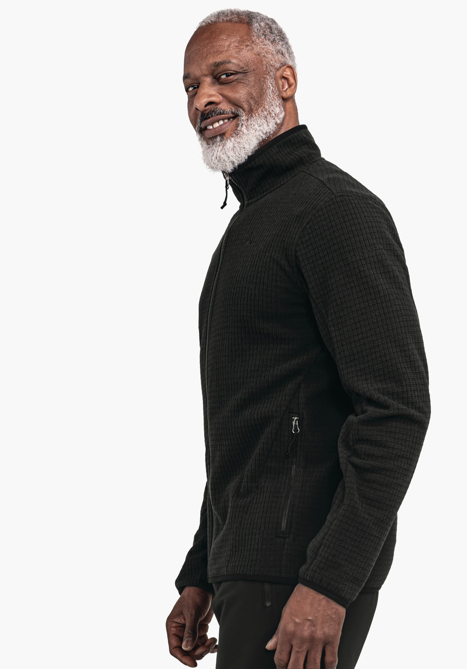 CIRC Fleece Jk Style Terxa MNS black jacket worn by a man standing side-on and smiling; white hair and beard visible; neutral light grey background; Schöffel logo on the chest.
