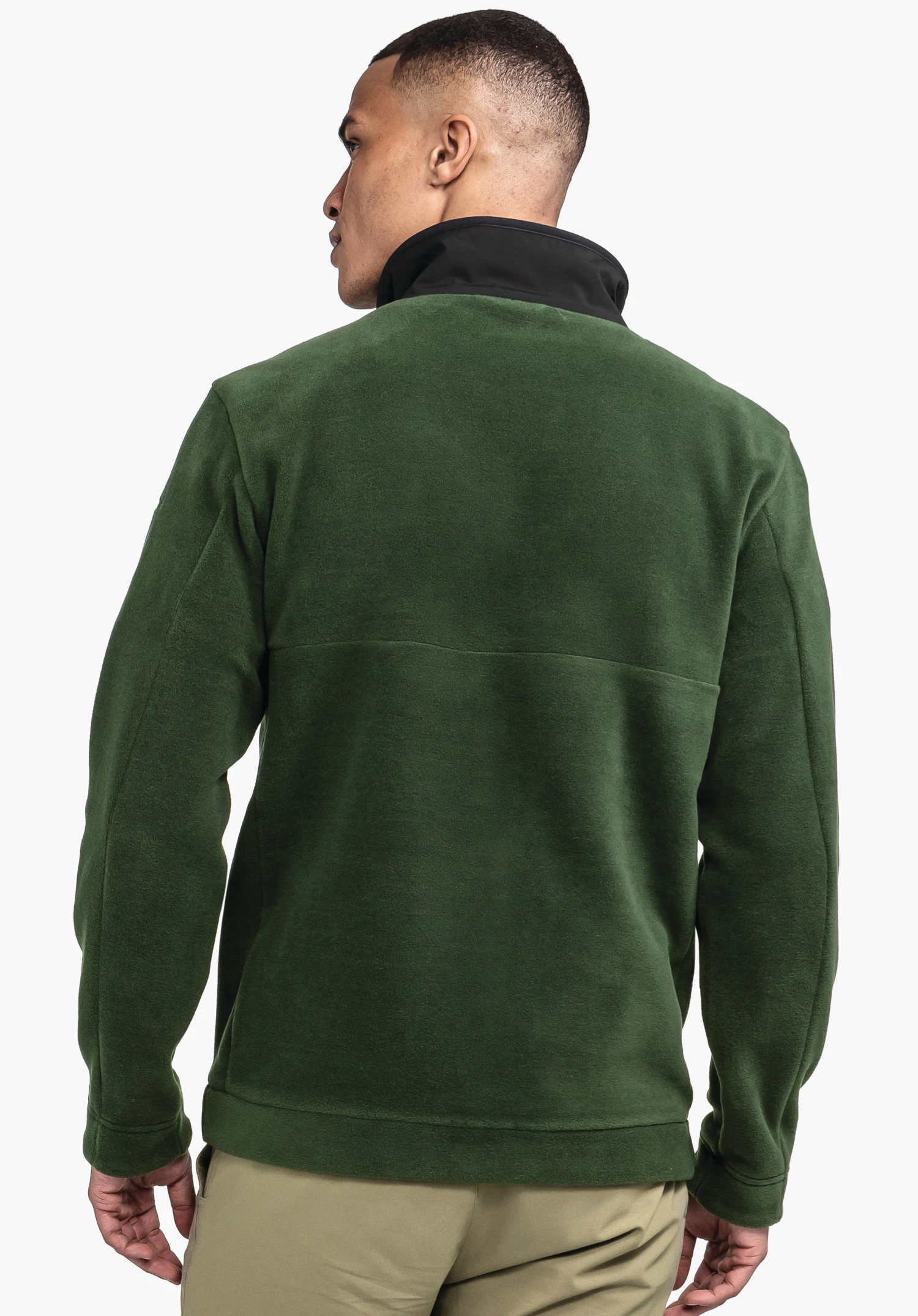 Fleece Jk Style Gregale MNS dark green fleece jacket worn by a man standing slightly turned; black stand collar visible; hands relaxed at the sides; neutral white background.