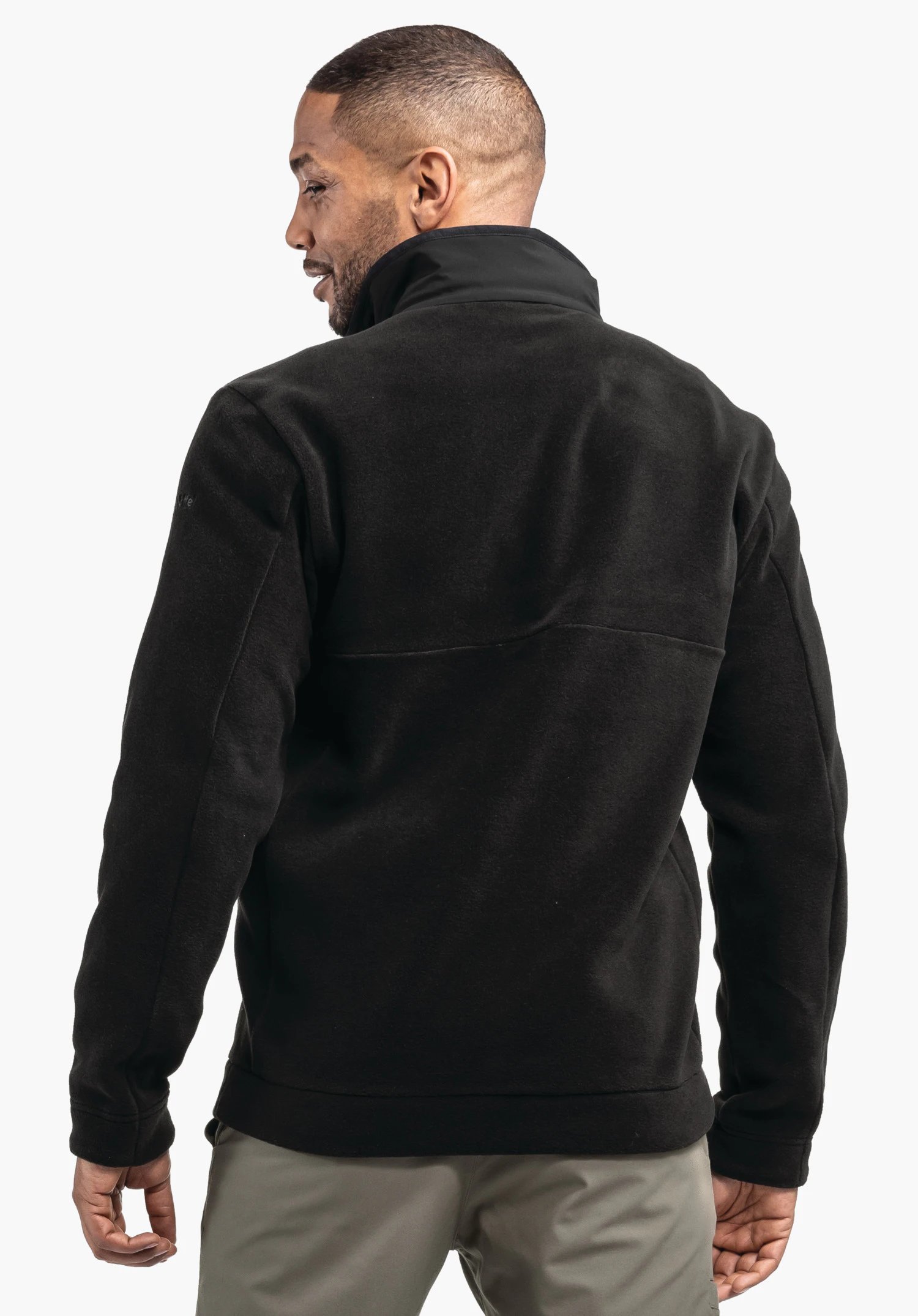 Fleece Jk Style Gregale MNS black fleece jacket worn by a person from the back; white background, light grey trousers visible.