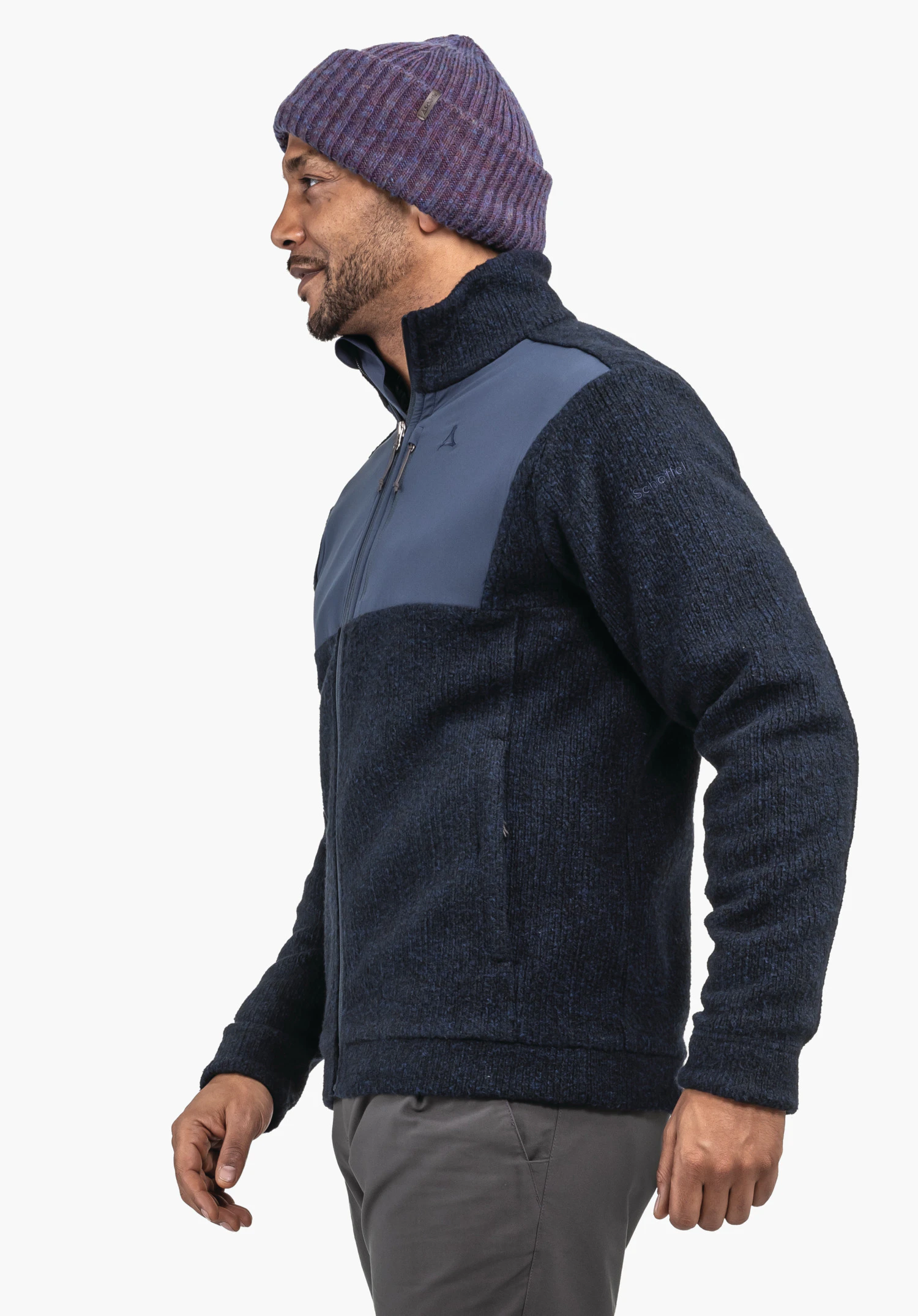 Fleece Jk Style Canterbury MNS dark blue fleece jacket with light blue chest panel, Schöffel logo on chest, lettering "Schöffel" on sleeve; worn side-on by a man wearing a dark purple beanie in front of a white background.