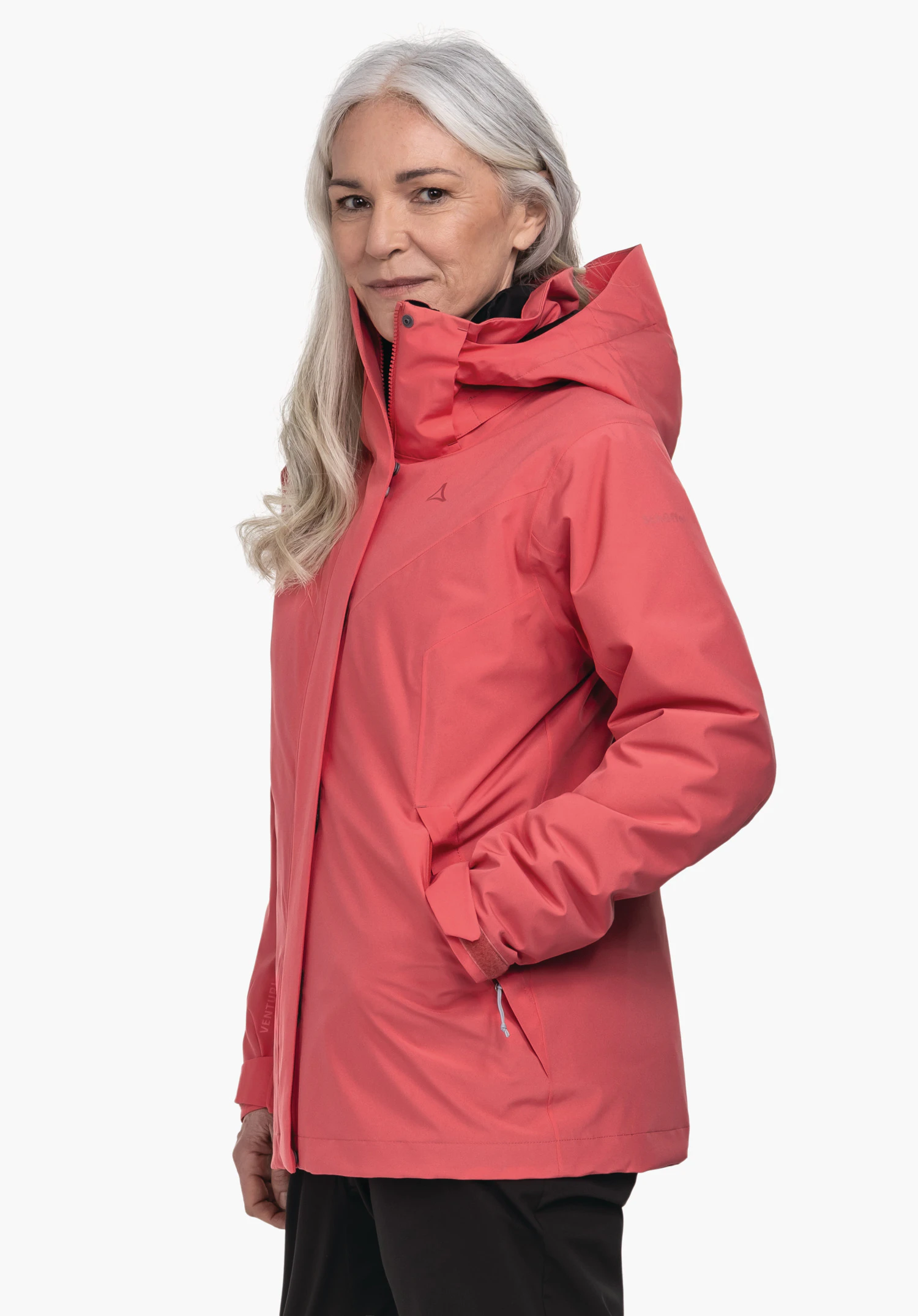 3in1 Jacket Style Tamina WMS red jacket worn by an older woman in side pose with hands in pockets, hood worn; Schöffel logo on chest; light solid background.