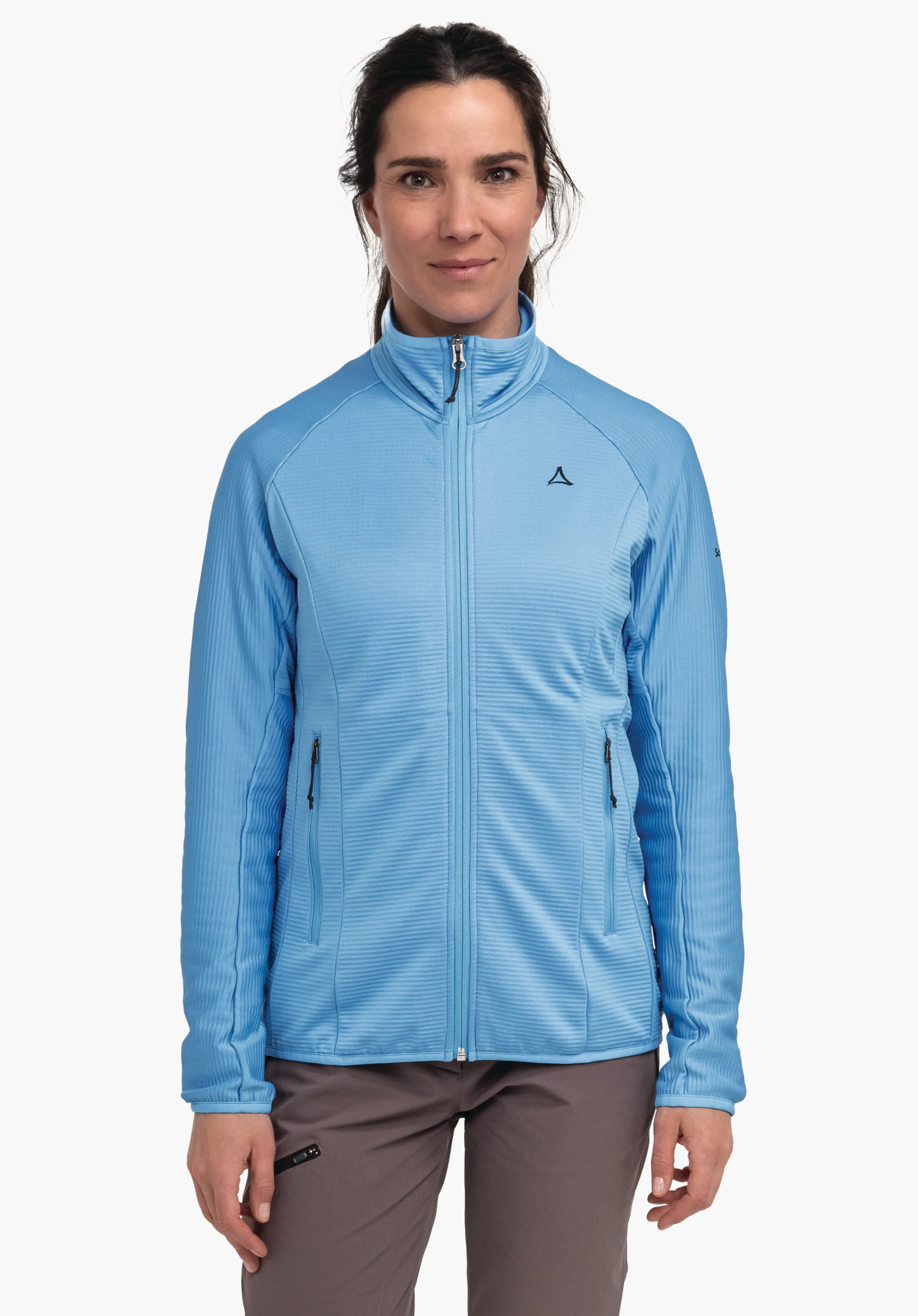 Fleece Jk Style Cascata WMS light blue jacket worn front-facing by a woman; zip fastening, stand-up collar, two zip pockets with fine ribbed structure; small Schöffel logo on the left chest; white background.