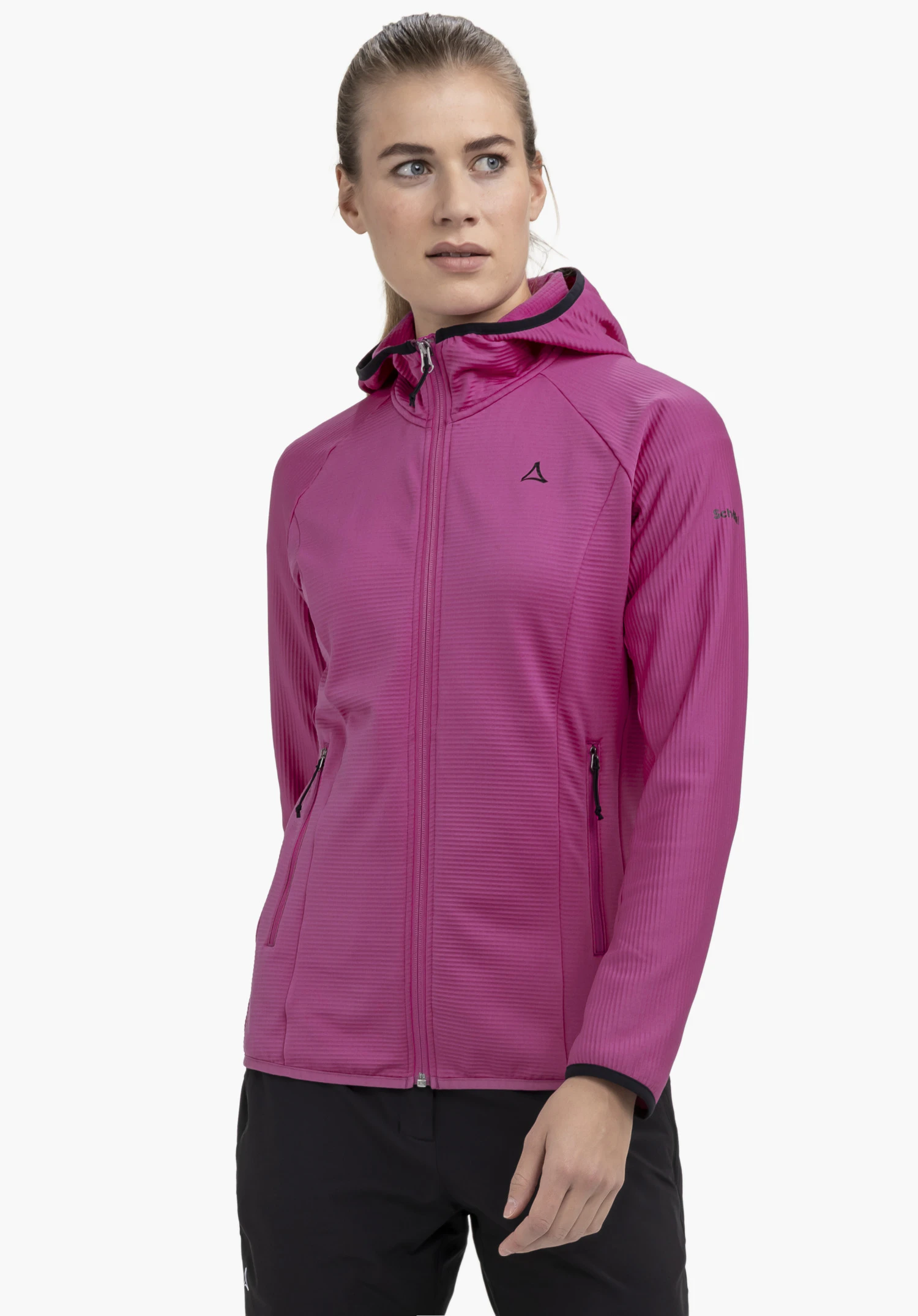 Fleece Hoody Style Cascata WMS is worn by a model standing slightly to the side in front of a neutral background. The pink fleece jacket features a full front zip, a hood, and the Schöffel logo on the left chest.