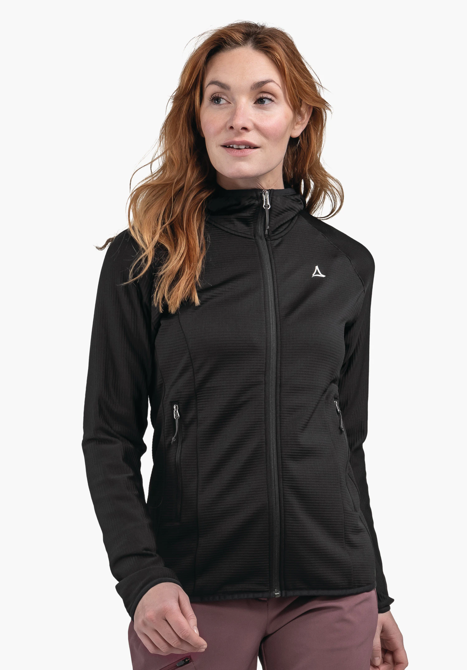 Fleece Hoody Style Cascata WMS black women’s jacket worn by a standing person with light red hair, looking sideways; full zip, two zip pockets; white Schöffel logo on the left chest; white background.