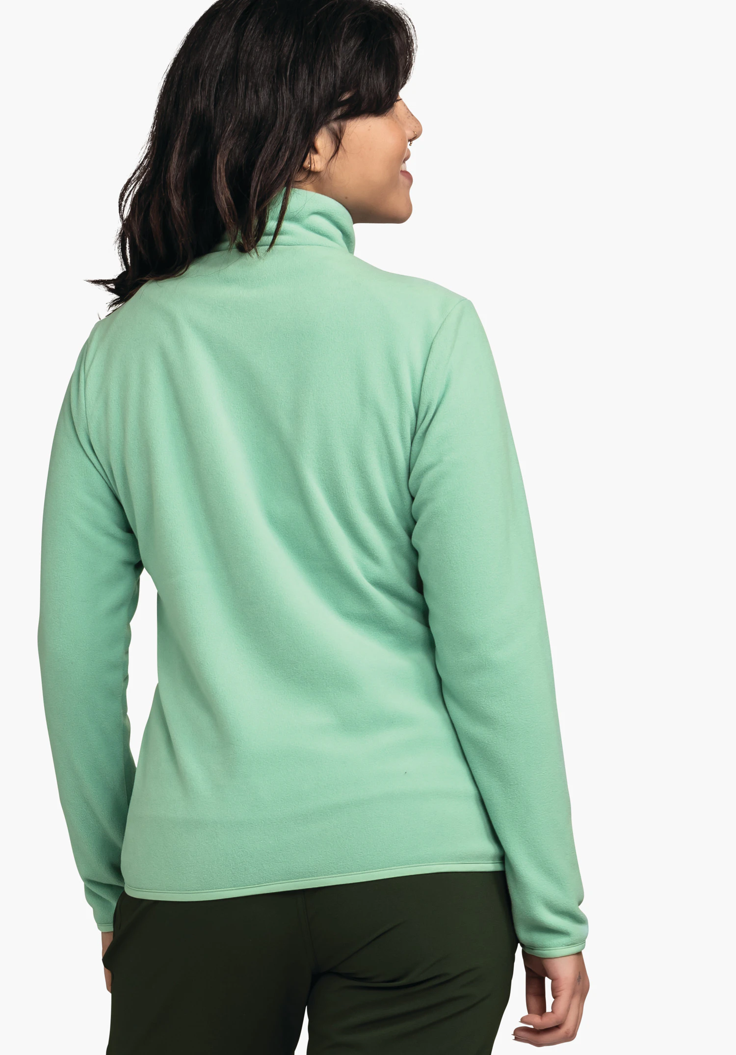 Fleece Jk Style Ash WMS light green fleece jacket worn by a person standing with back to the camera and looking right; black hair, dark green trousers; white background.