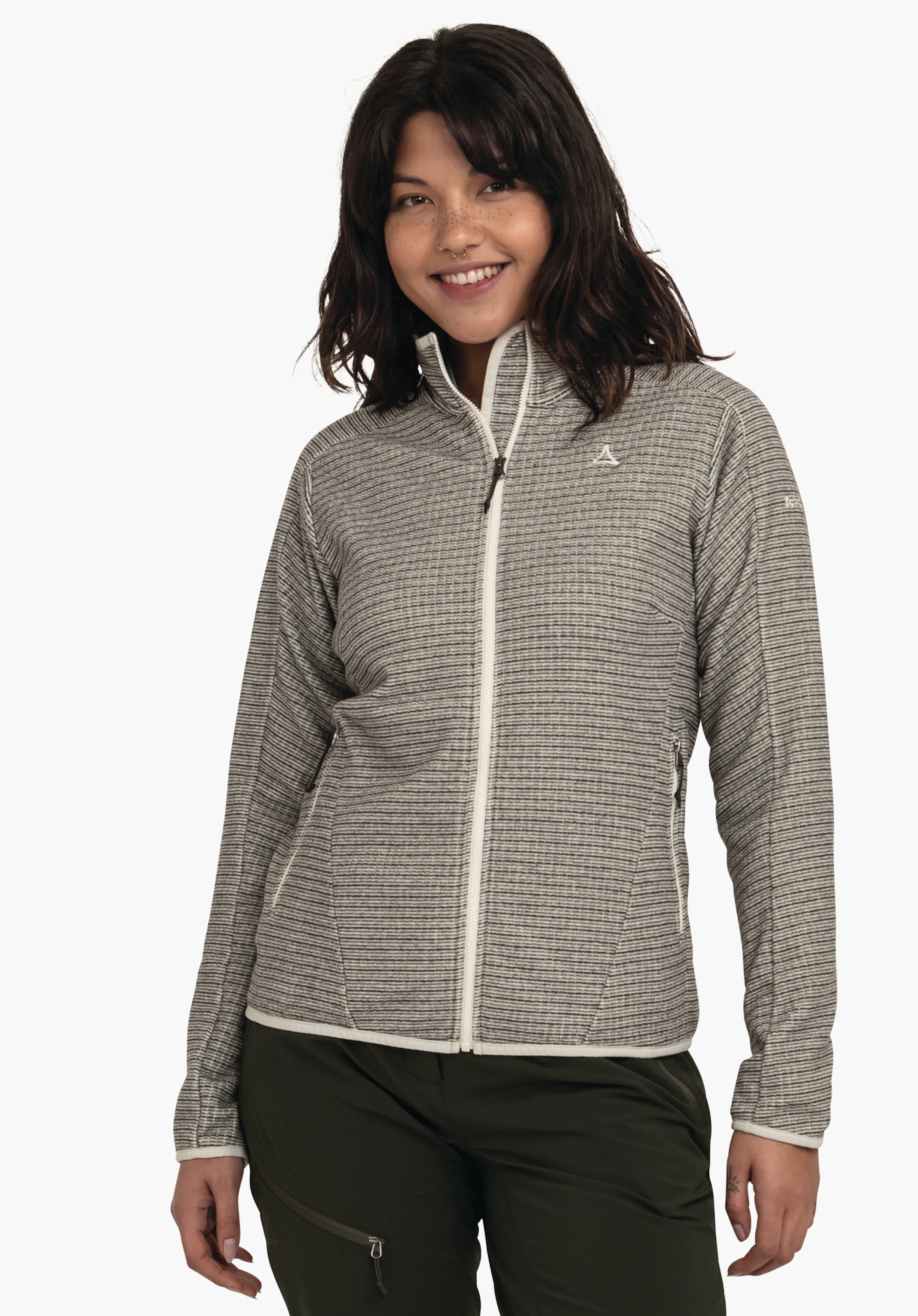 CIRC Fleece Jk Style Terxa WMS jacket worn by a smiling woman; zip jacket with Schöffel logo, standing in front of a white background, paired with dark green trousers.