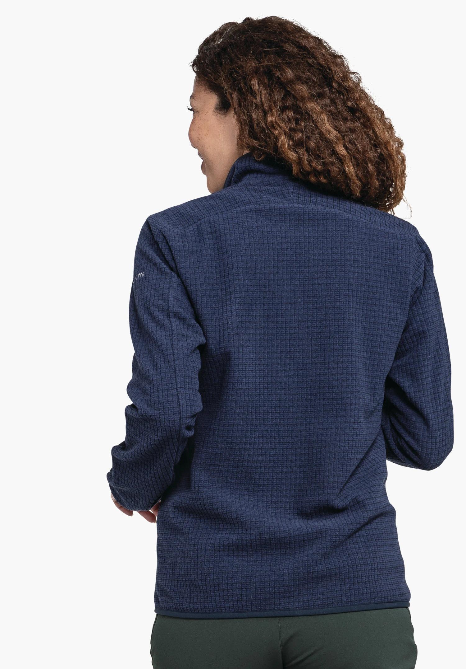 CIRC Fleece Jk Style Terxa WMS dark blue fleece jacket worn by a person turning their head left; jacket covers the back, curly dark brown hair visible; standing pose against a plain white background.