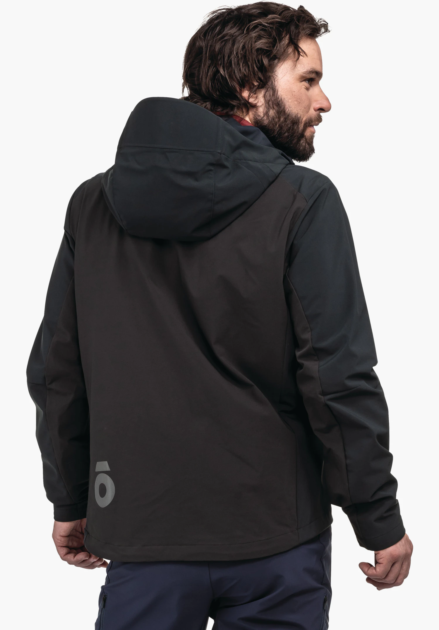 Hybrid Jk Style Salza MNS dark grey jacket worn by a man looking over his shoulder; stands against a bright white background; small light grey logo at the lower back.