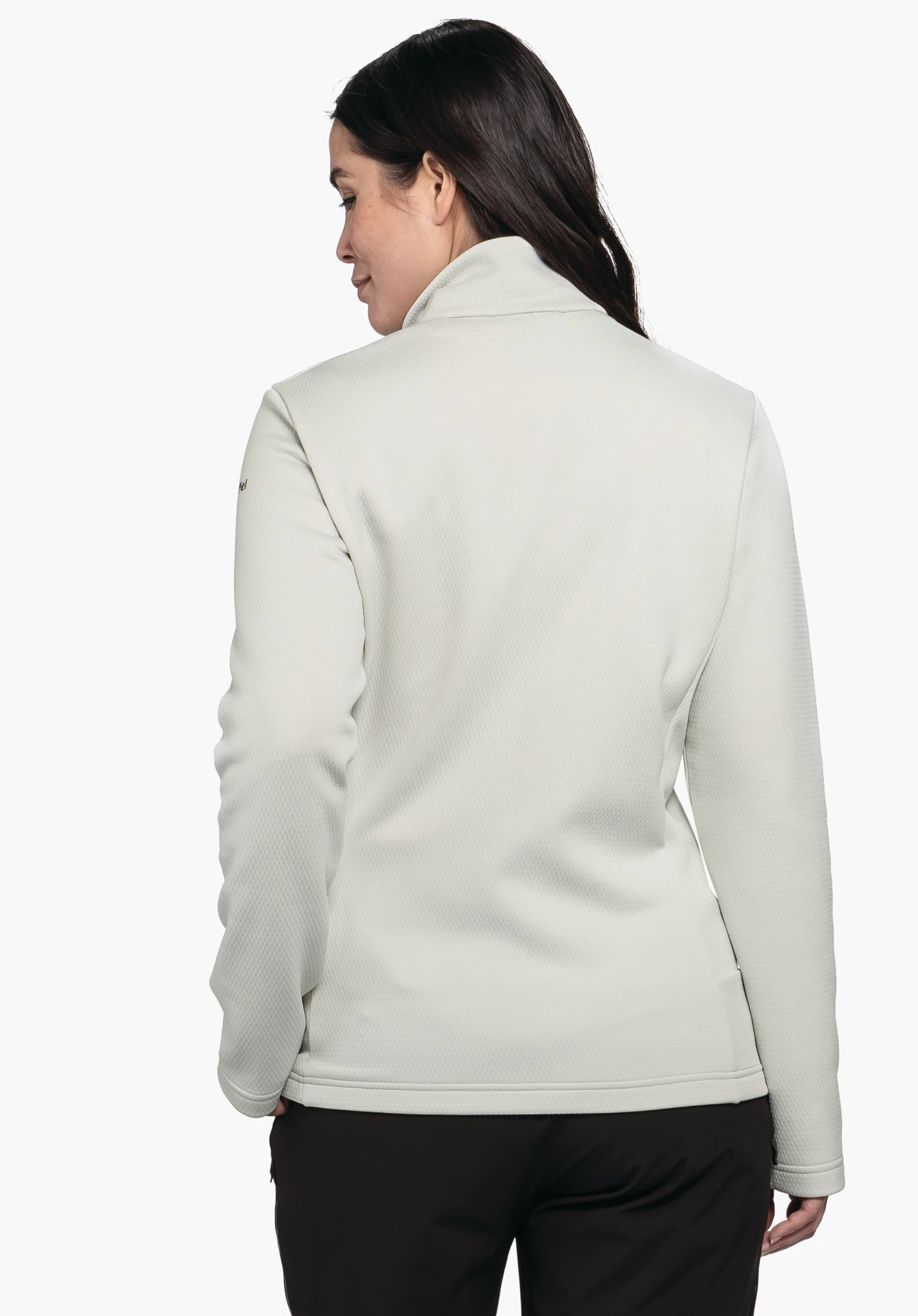 Fleece Jk Style Pine WMS veste blanc clair, personne debout dos à la caméra, tête légèrement tournée sur le côté; contexte: fond studio blanc épuré, pantalon foncé visible en bas de l’image.