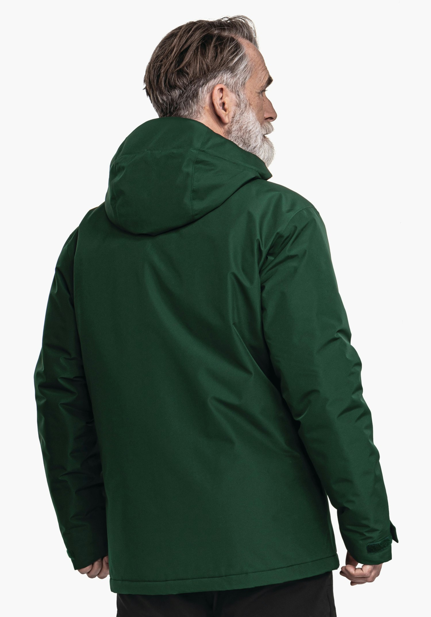 Ins Jacket Style Wildkar MNS dark green jacket worn by an older man; standing with his back to the camera, head turned right; hood up, grey beard; white background.