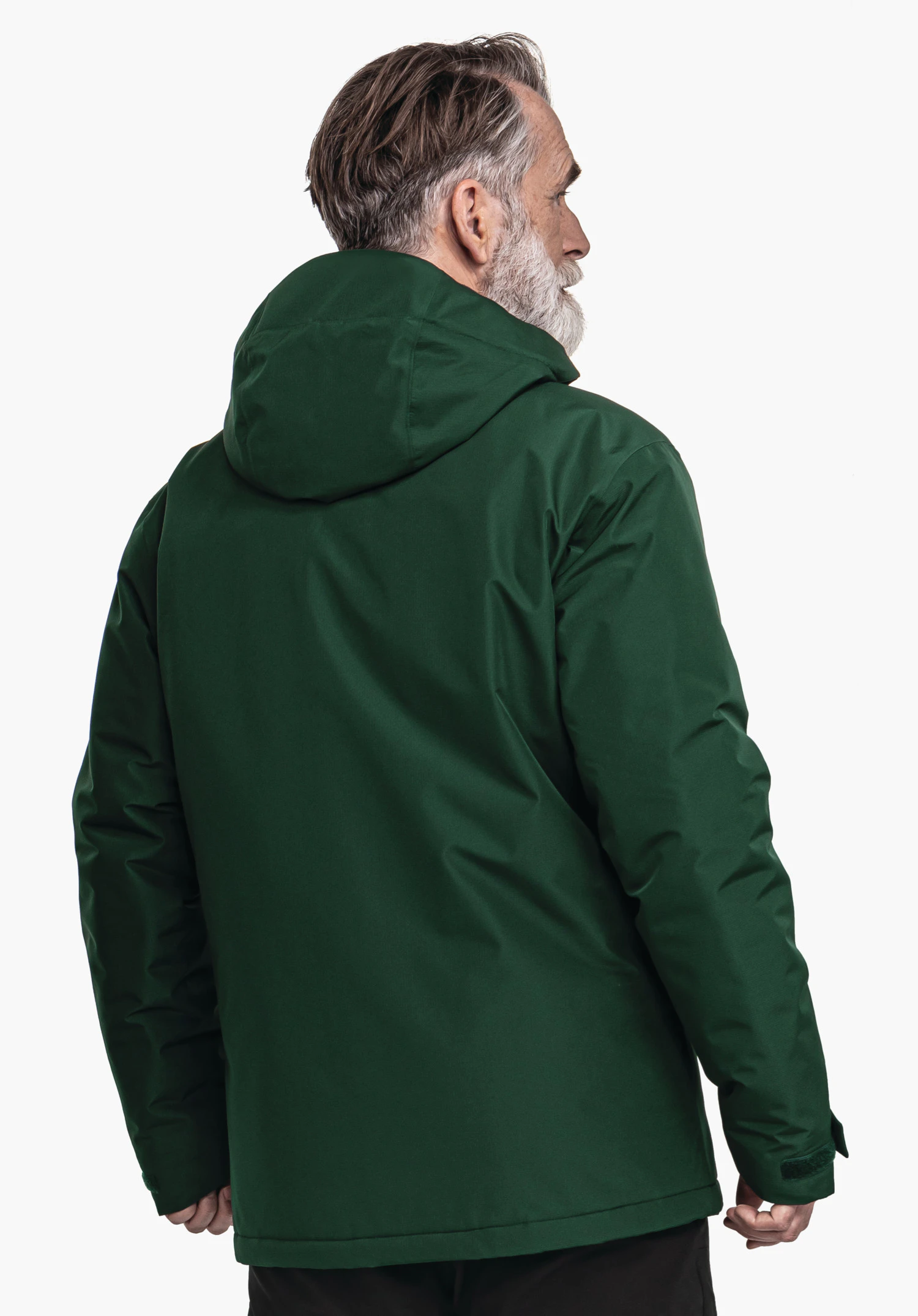 Ins Jacket Style Wildkar MNS dark green jacket worn by an older man; standing with his back to the camera, head turned right; hood up, grey beard; white background.