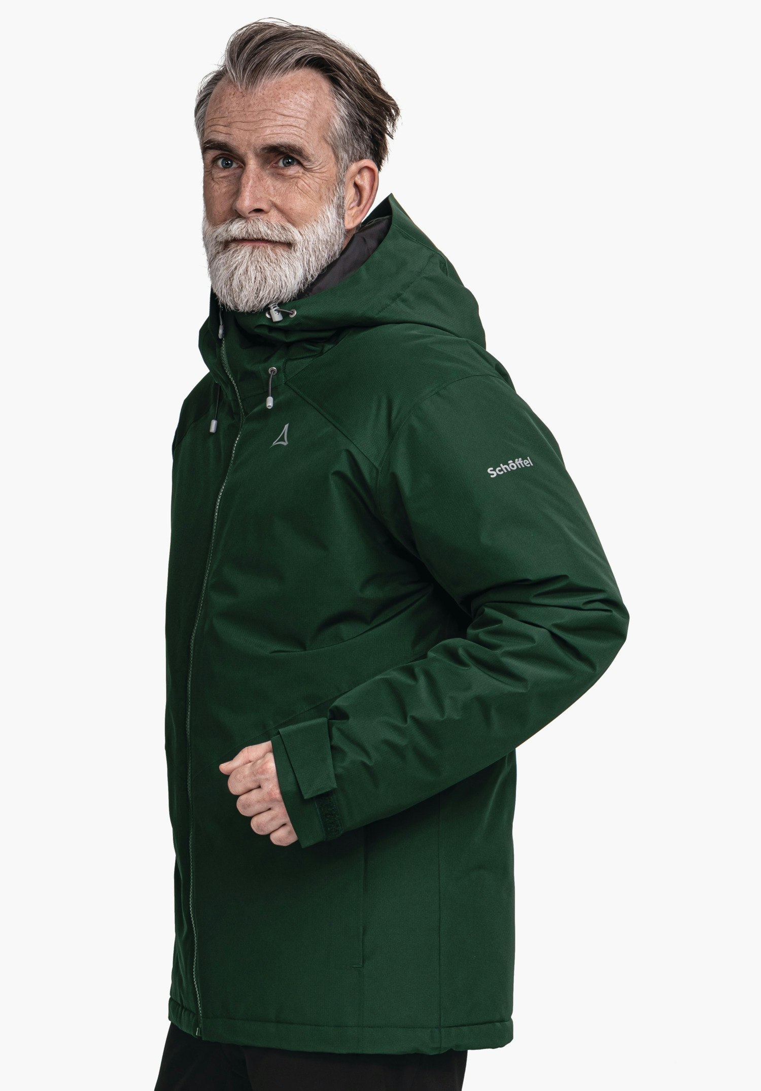 Ins Jacket Style Wildkar MNS dark green hooded jacket worn by a man standing slightly side-on; white studio background; Schöffel logo visible, lettering on sleeve: "Schöffel".