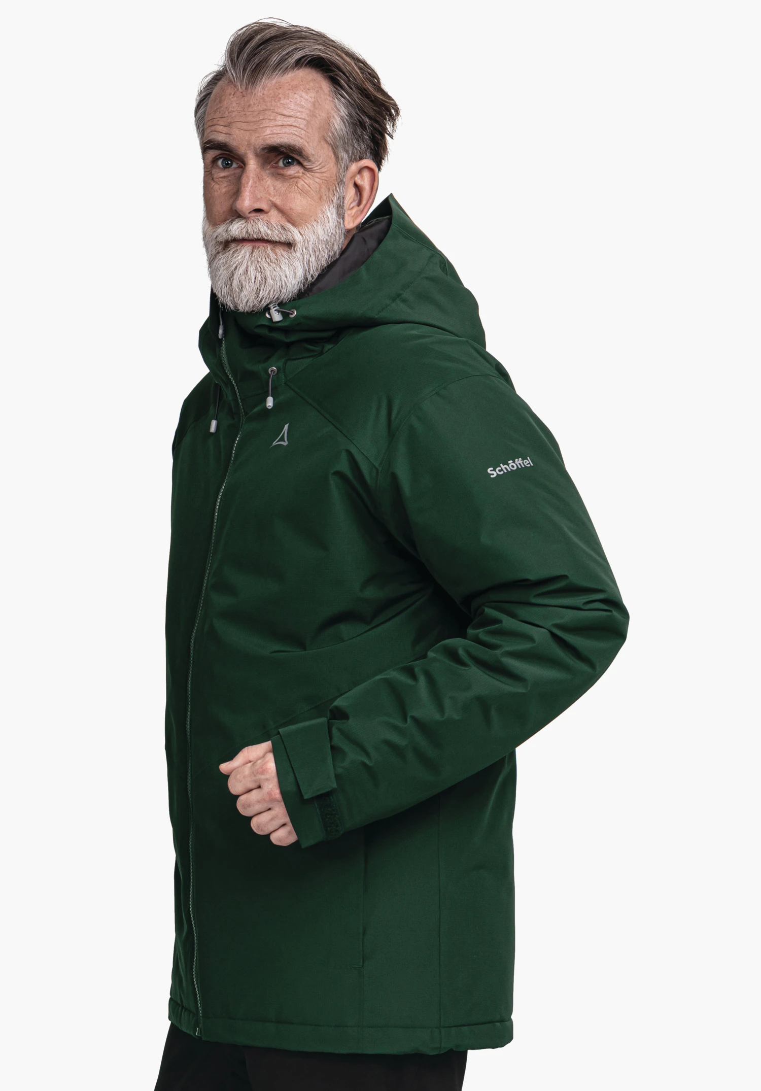 Ins Jacket Style Wildkar MNS dark green hooded jacket worn by a man standing slightly side-on; white studio background; Schöffel logo visible, lettering on sleeve: "Schöffel".