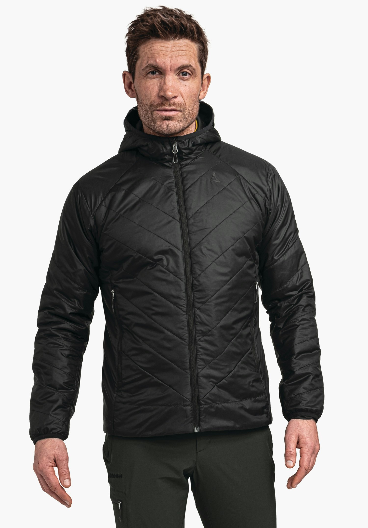 Ins Jacket Style Cascata MNS black quilted jacket, worn by a man standing front-facing against a light grey background; Schöffel logo on the chest, “Schöffel” lettering on the trousers.