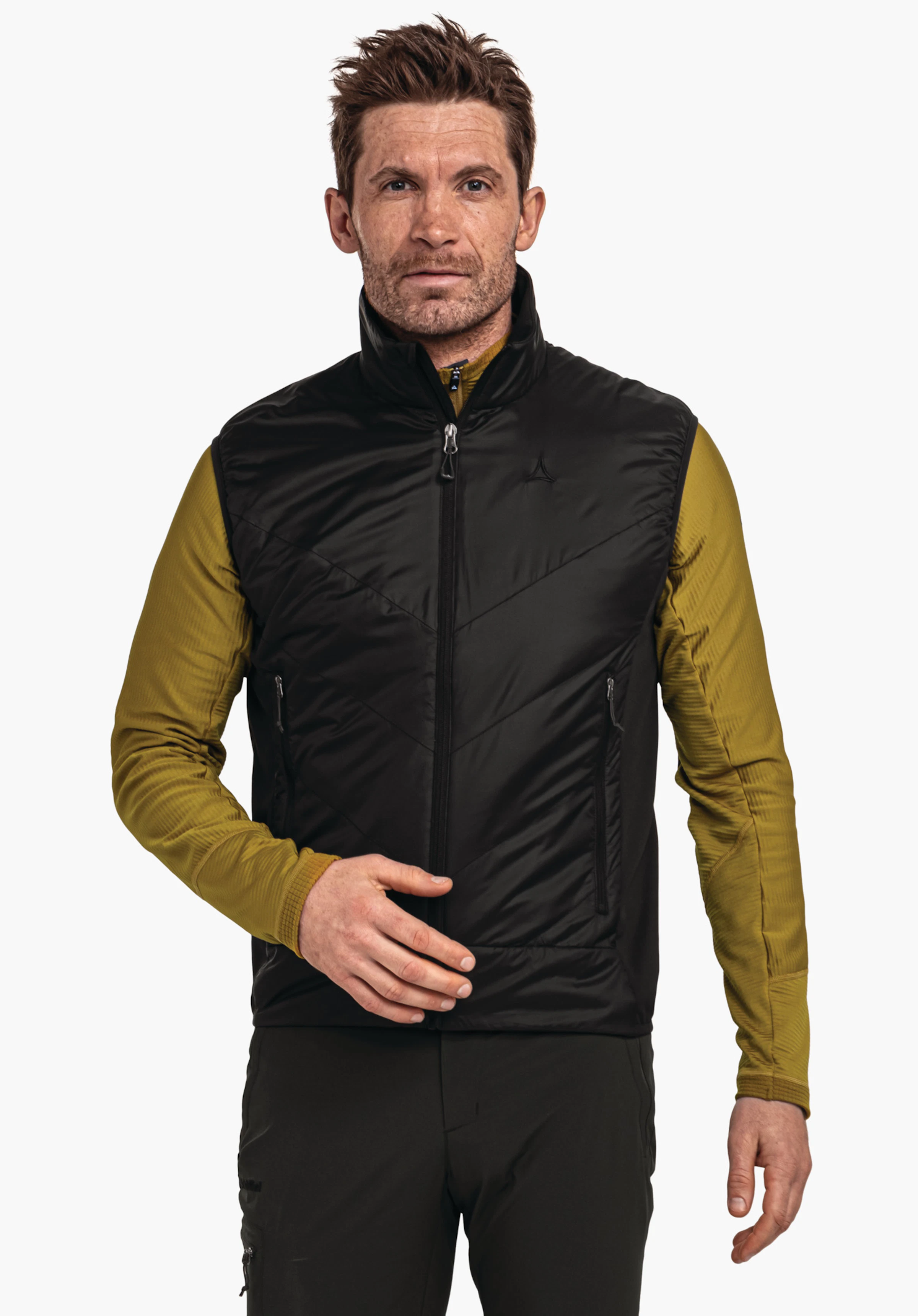 Down Jacket Style Cascata MNS donkerblauwe gewatteerde jas, gedragen door een man die naar rechtsboven kijkt; Schöffel-logo op de borst, tekst "Schöffel" op de donkergroene broek; witte studioachtergrond.