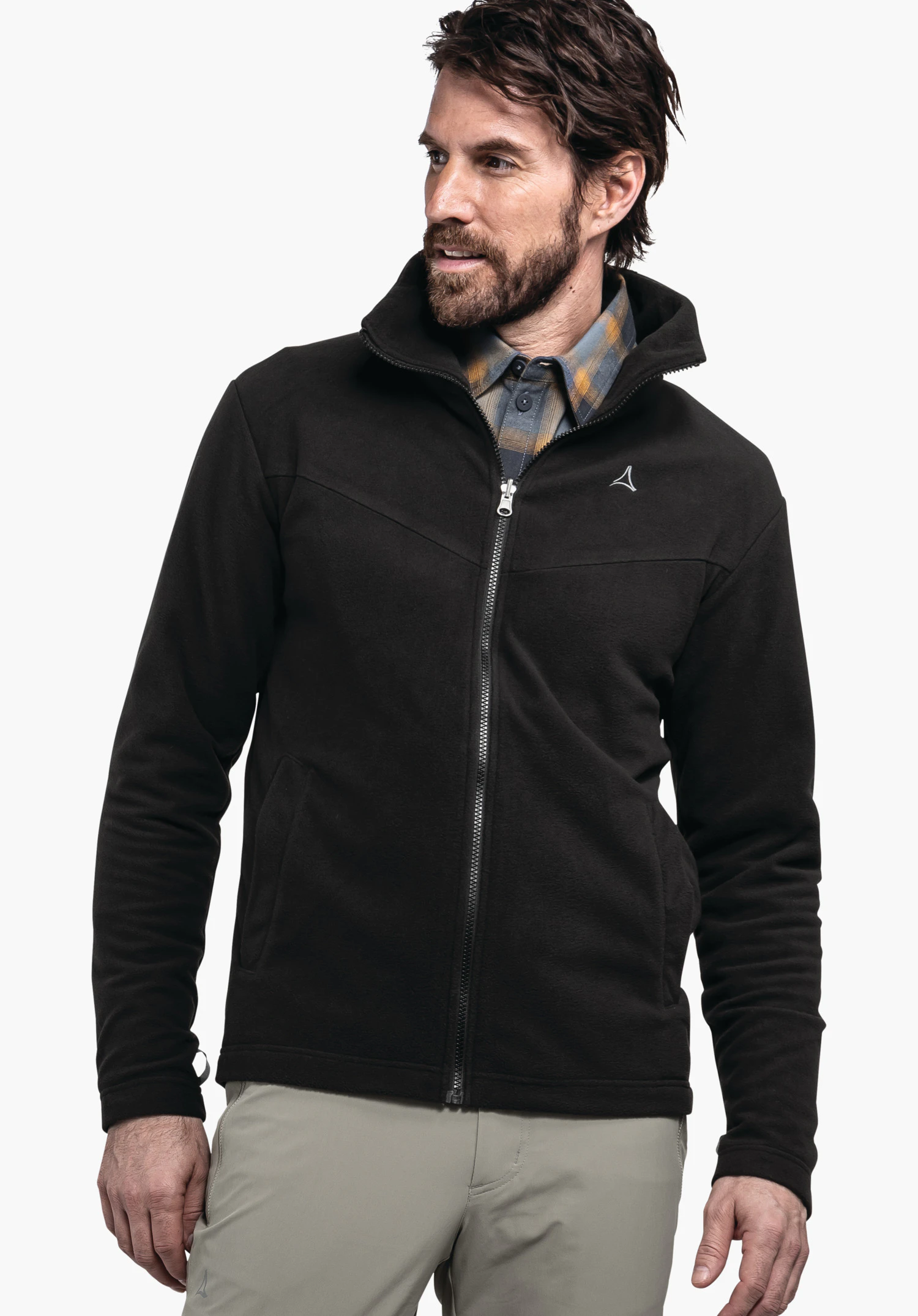 3in1 Jacket Style Okere MNS black fleece jacket, worn by a standing man; zipper closed, Schöffel logo on the chest; dark blue and yellow checked shirt underneath; light white background.