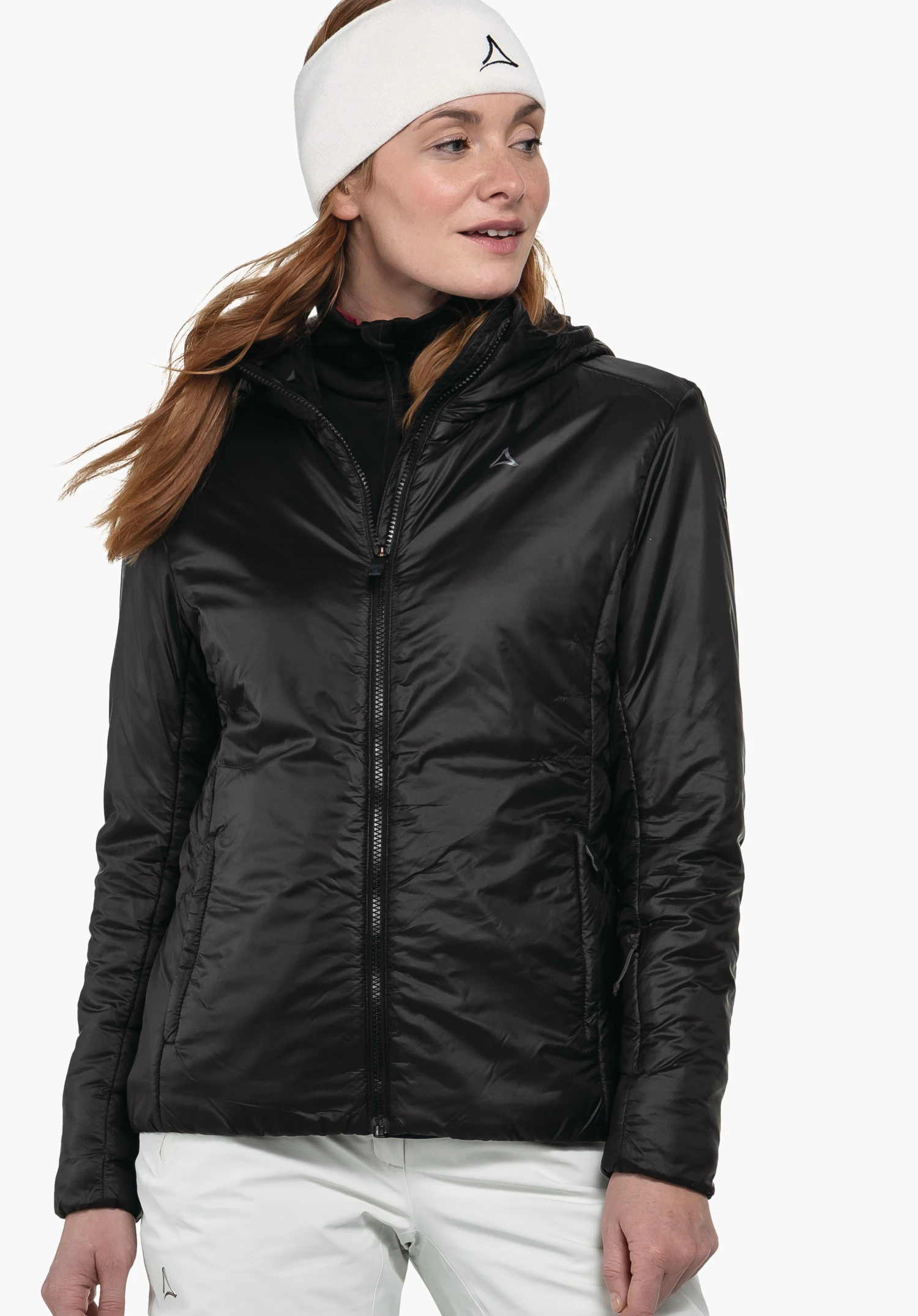 Ins Jacket Style Pontre WMS woman wears a black quilted jacket with zip and hood, looking sideways; wearing a white headband with Schöffel logo; light neutral background.