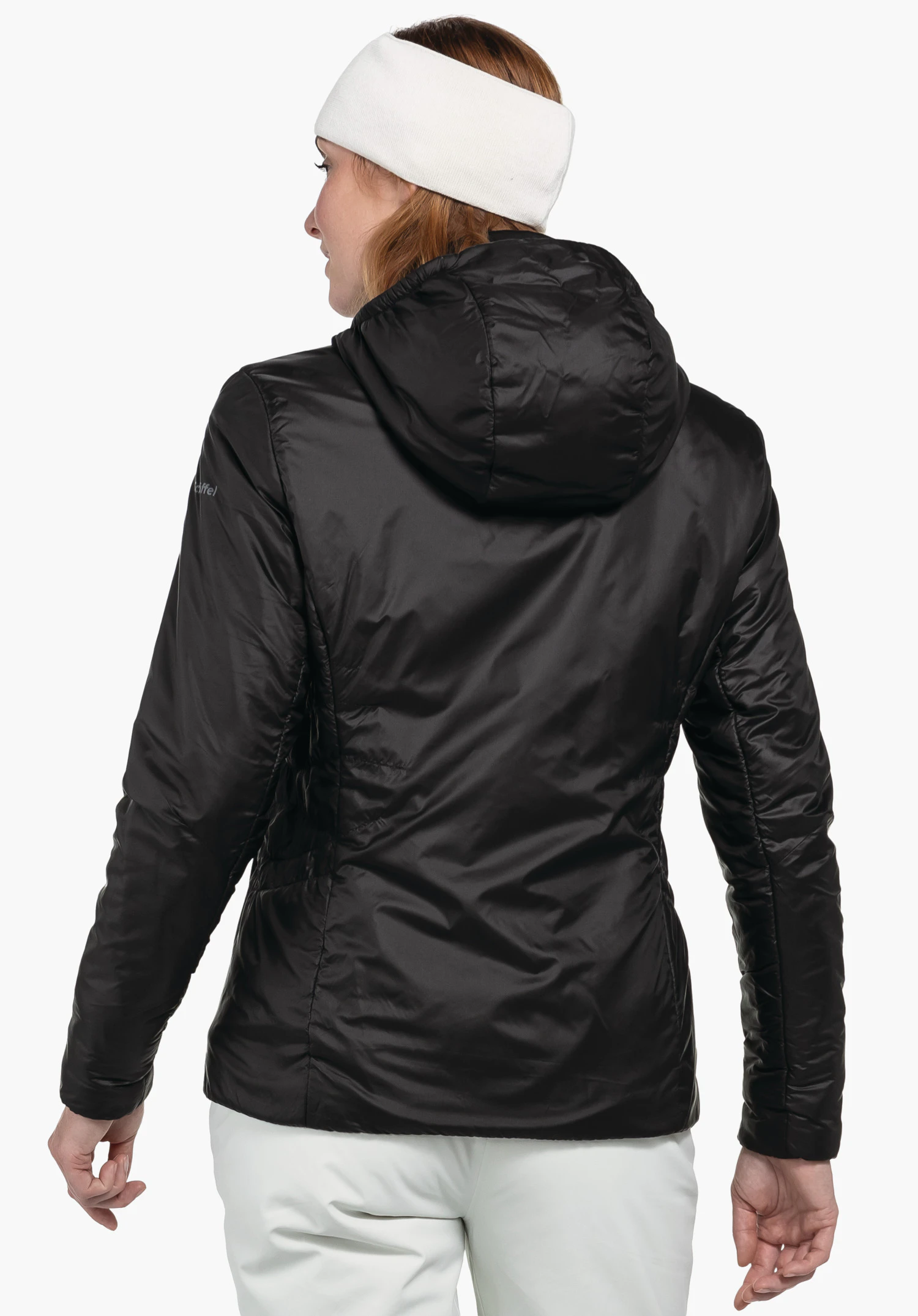 Ins Jacket Style Pontre WMS black hooded jacket worn by a person with back to the viewer, head turned to the left; white headband, white trousers; white background. Sleeve text: “Schöffel”.