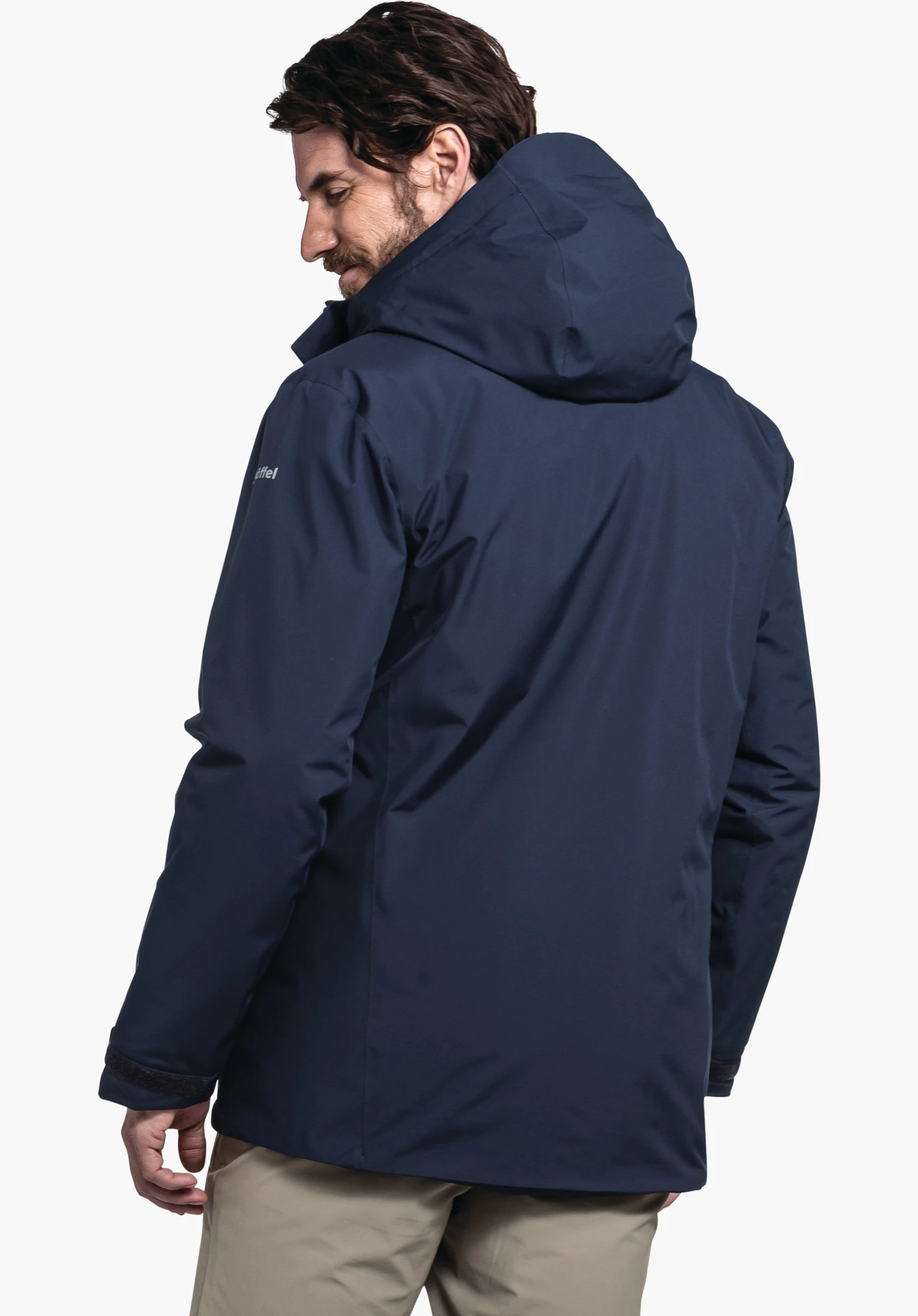 Parka Style Froda MNS in blue with Schöffel lettering on the shoulder, worn by a male model shown from the back with the hood up and his head turned slightly to the side against a white background. (AI-generated)