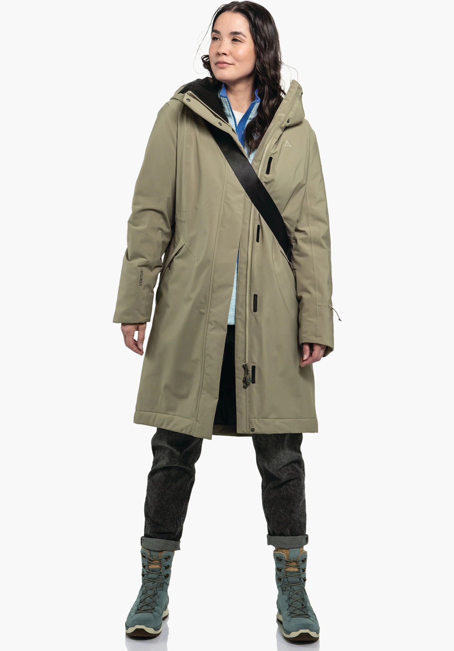 Ins Coat Style Gregale WMS. Die Textur des braunen Oberstoffs, die Abdeckleiste und das Schöffel-Logo auf der Brust. Nahaufnahme vor weißem/neutralem Hintergrund.