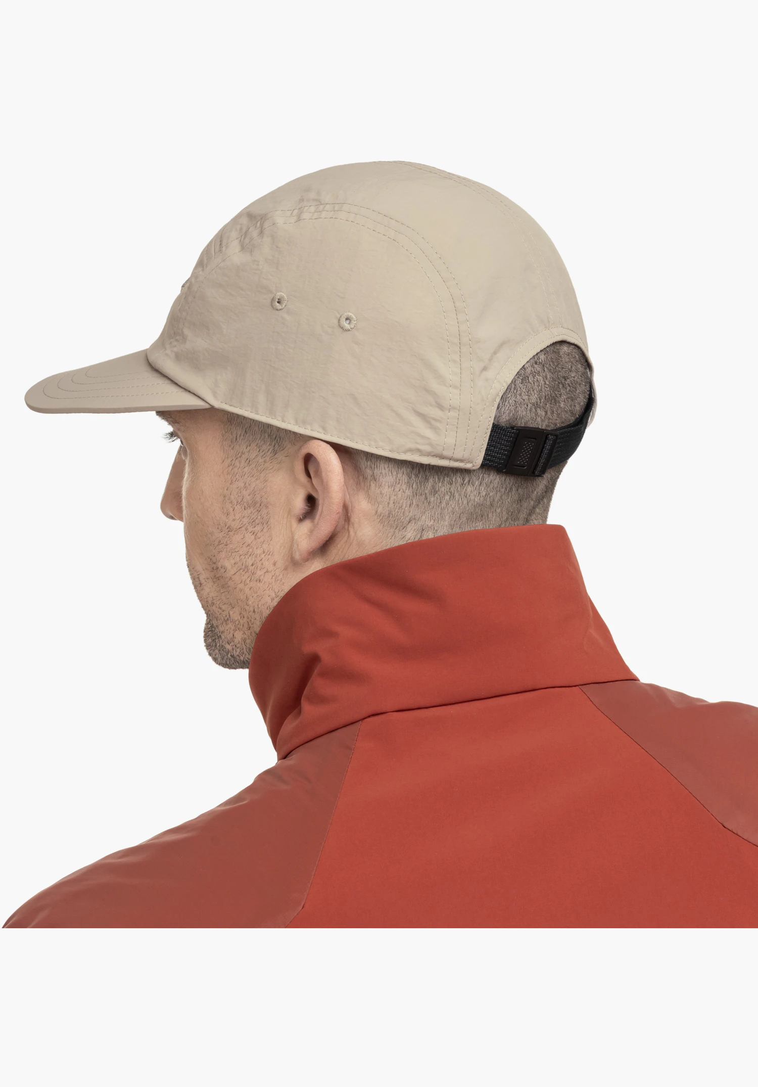 Sun Cap in beige, focusing on the black adjustable strap at the back and the ventilation eyelets in the lightweight fabric, close-up against a white/neutral background.