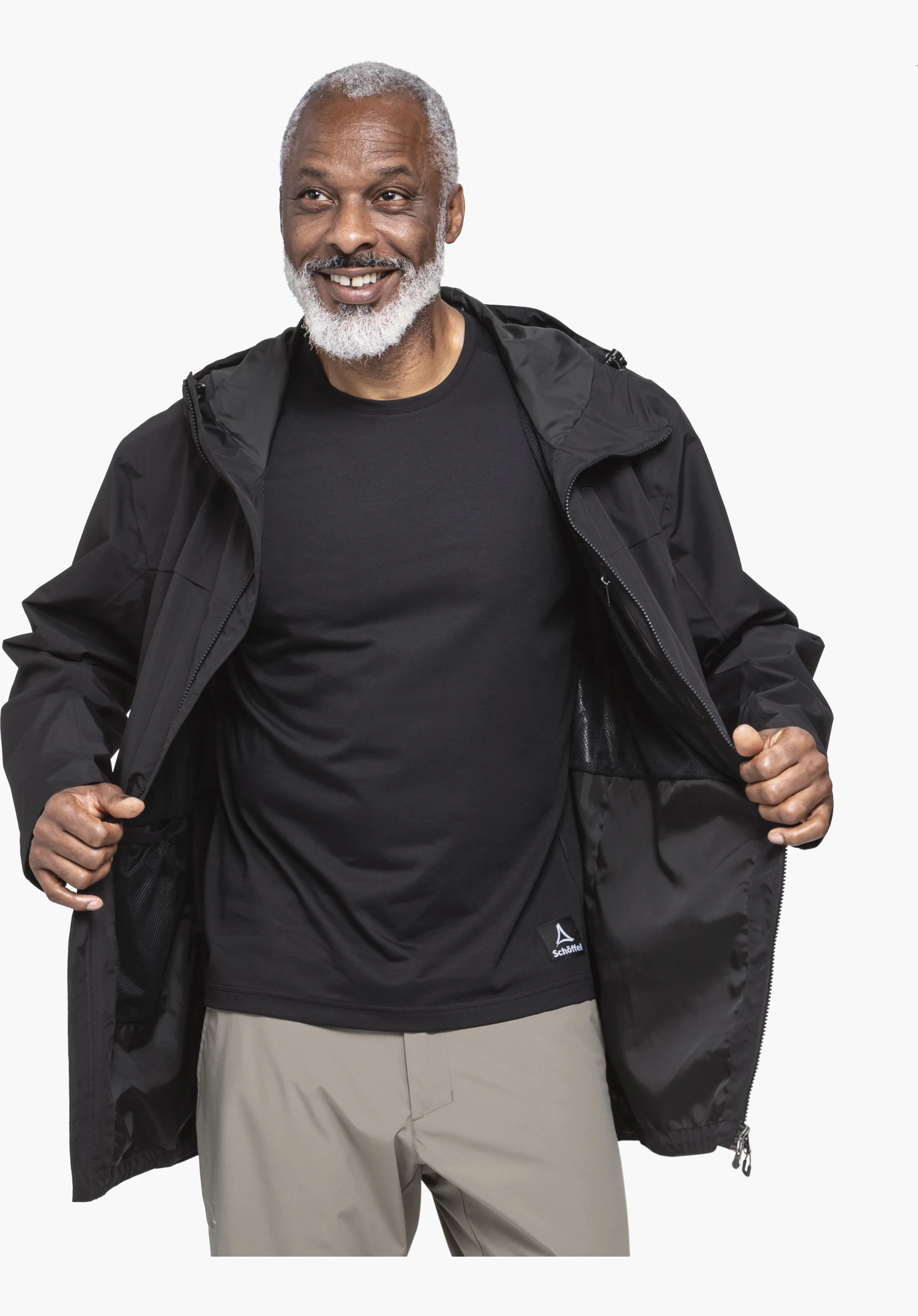 Parka Style Bohorok MNS se concentrant sur la doublure intérieure noire ouverte, les détails de la fermeture éclair et le Schöffel-Logo visible sur le t-shirt en dessous, en gros plan sur fond blanc/neutre.
