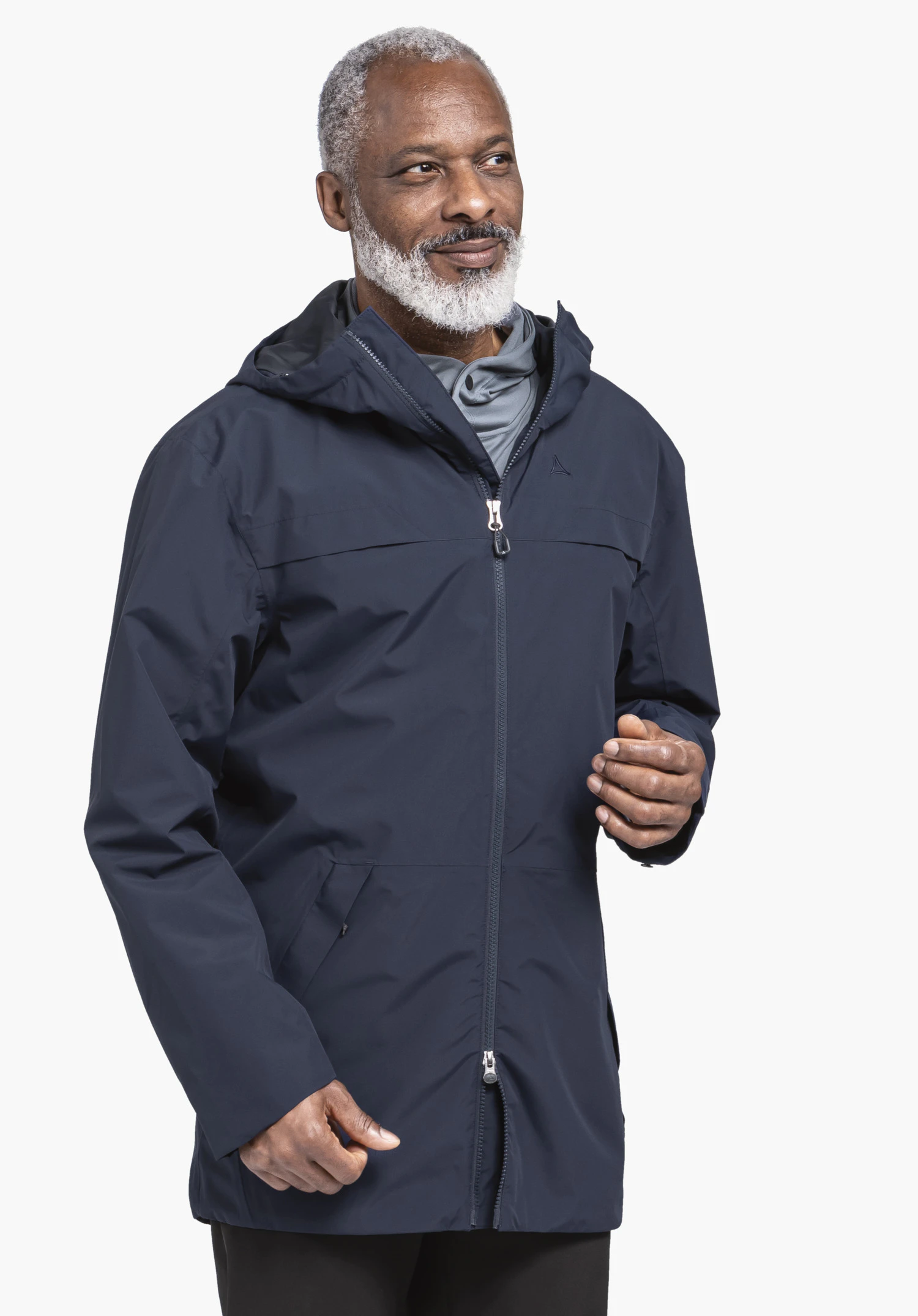 Parka Style Bohorok MNS. Un mannequin se tient légèrement de profil et porte la parka bleue, avec le logo Schöffel visible sur la poitrine gauche. La veste est présentée sur un fond neutre.