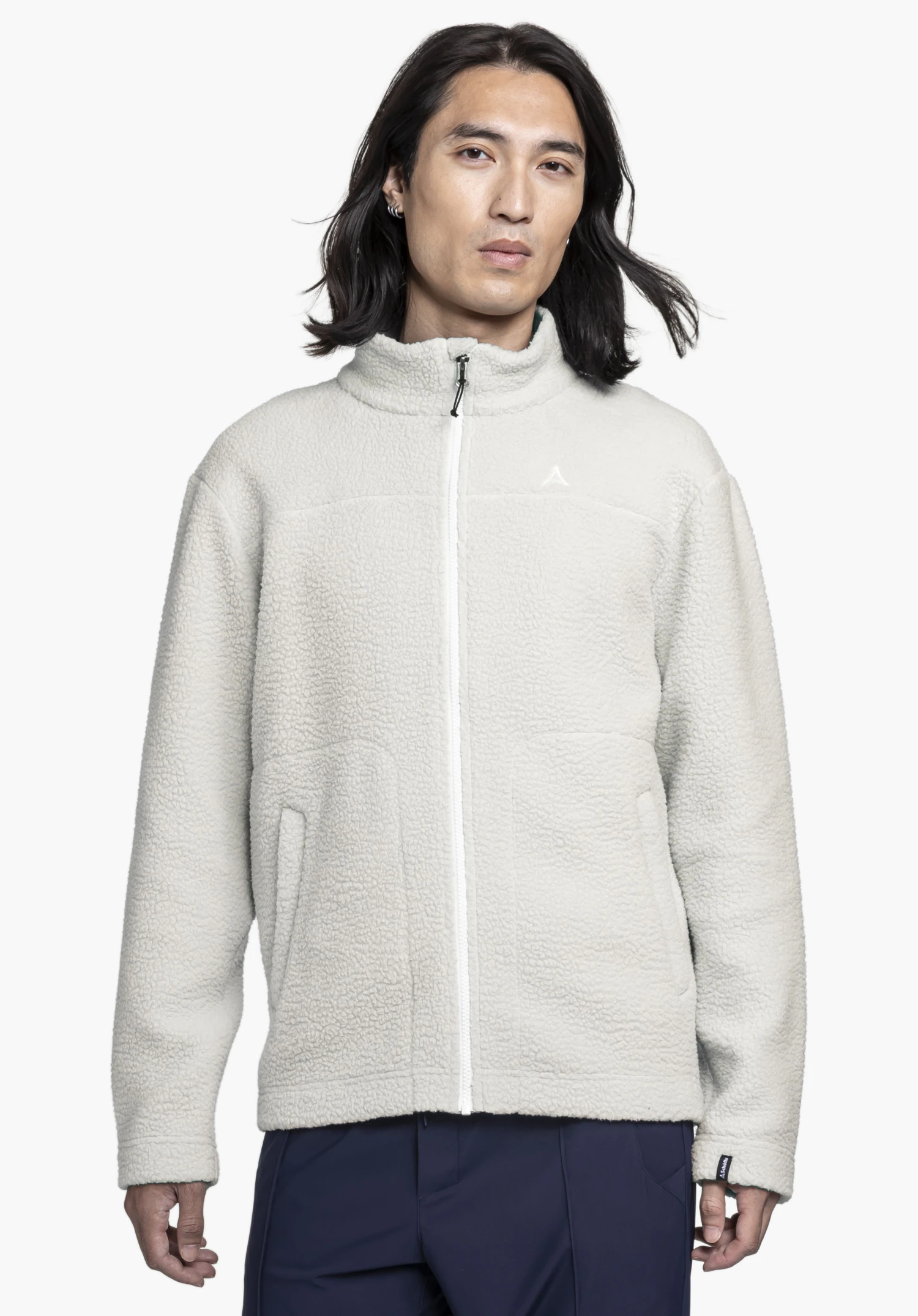 CIRC Fleece Jk Style Purga MNS. A model stands frontally wearing the soft fleece jacket in the colour natur. The subtle Schöffel logo is visible on the left chest. The wear view is shown against a neutral background.