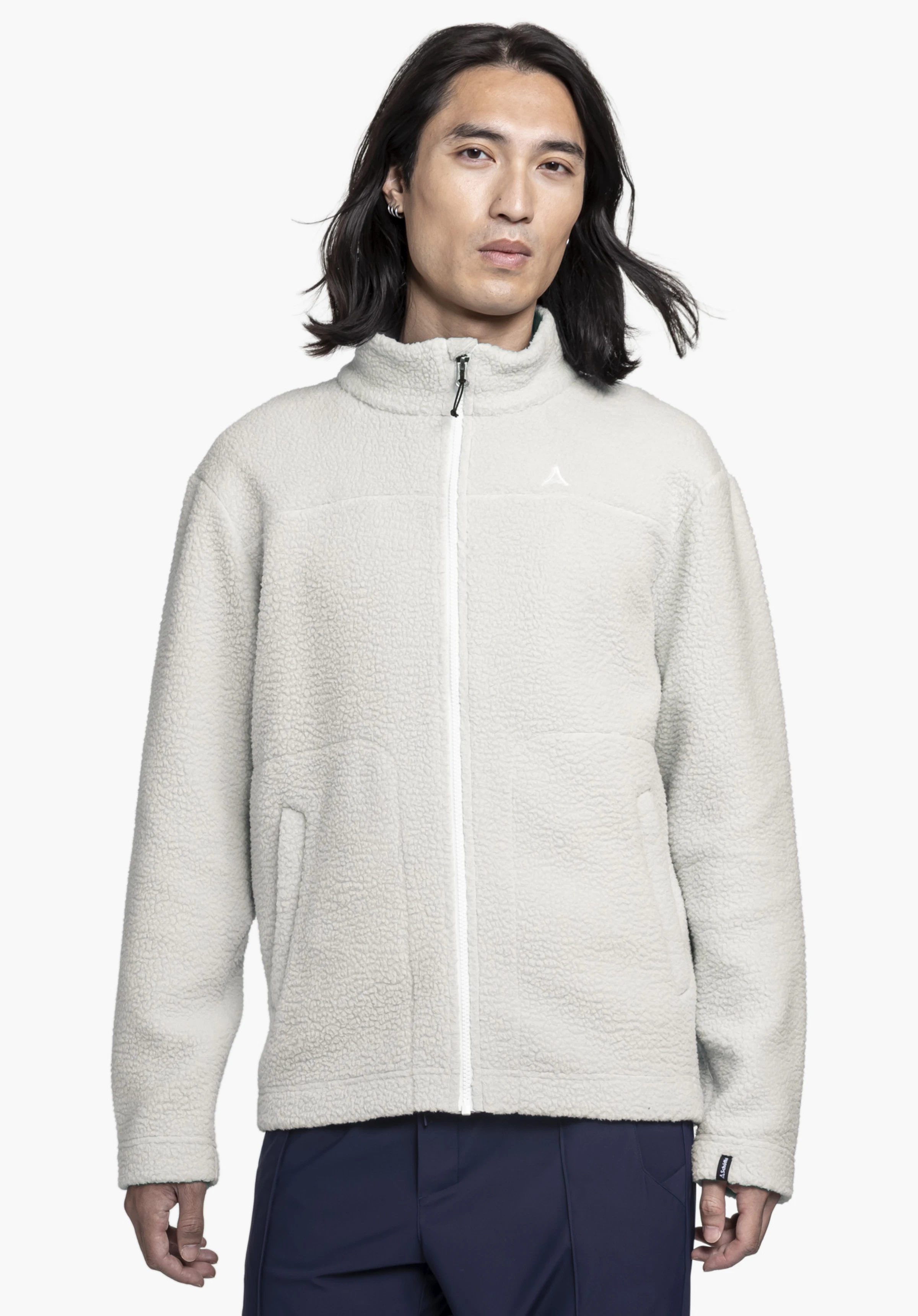 CIRC Fleece Jk Style Purga MNS. Ein Model steht frontal und trägt die weiche Fleecejacke in der Farbe natur. Auf der linken Brust ist das dezente Schöffel-Logo zu sehen. Die Trageansicht wird vor einem neutralen Hintergrund gezeigt.