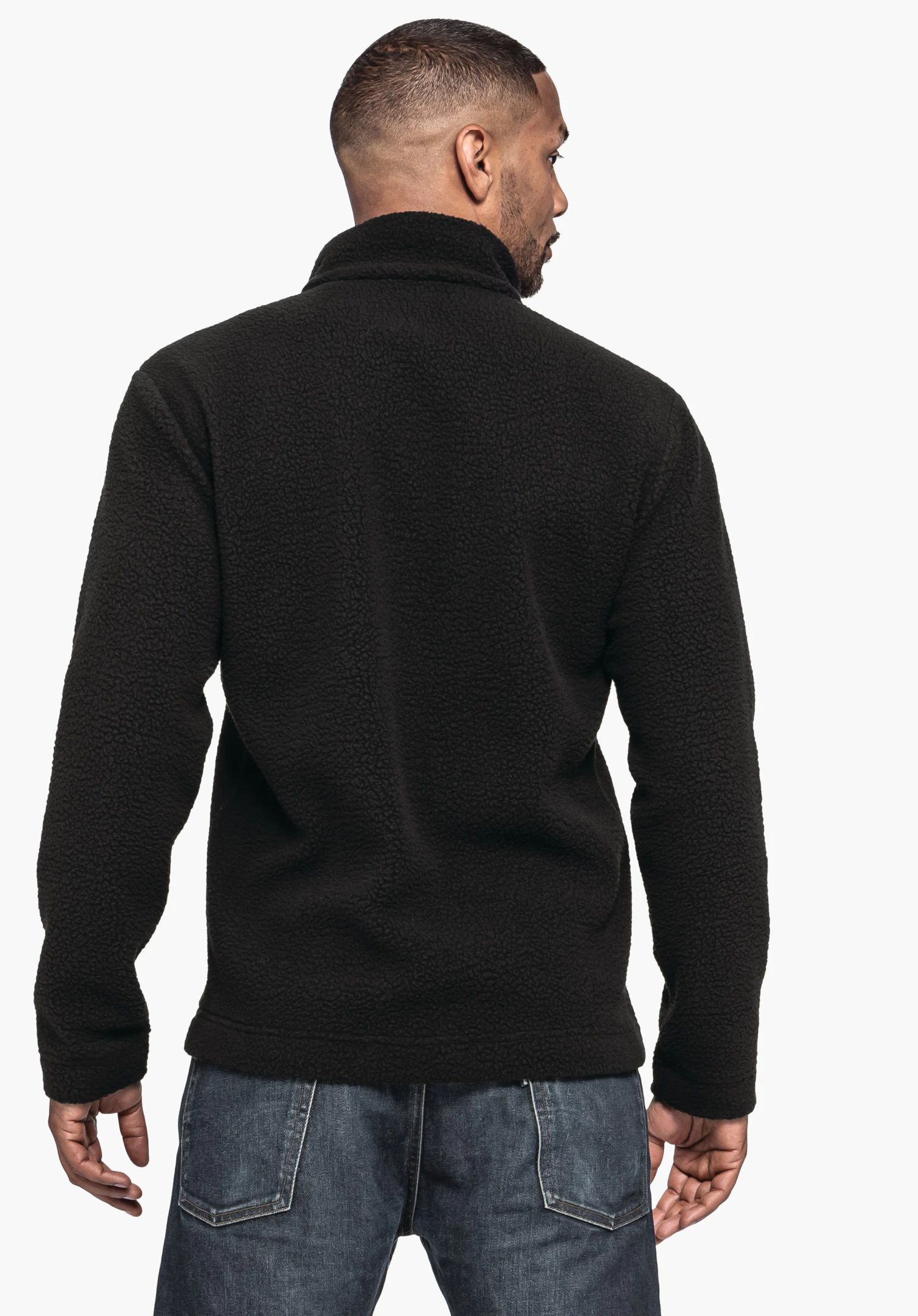 CIRC Fleece Jk Style Purga MNS in black. A model is seen from the back view wearing the textured fleece jacket against a neutral background.