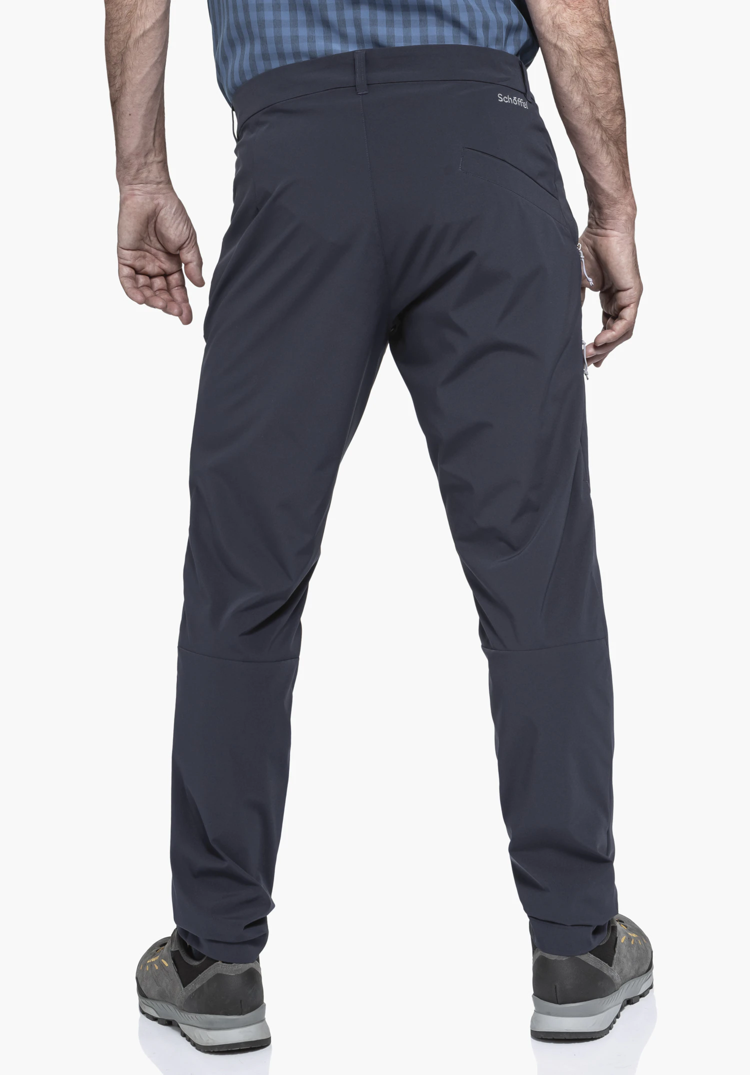CIRC Pants Style Smue MNS worn by a model in a back view. The blue trousers feature the Schöffel logo on the back right below the waistband and are presented against a neutral background.