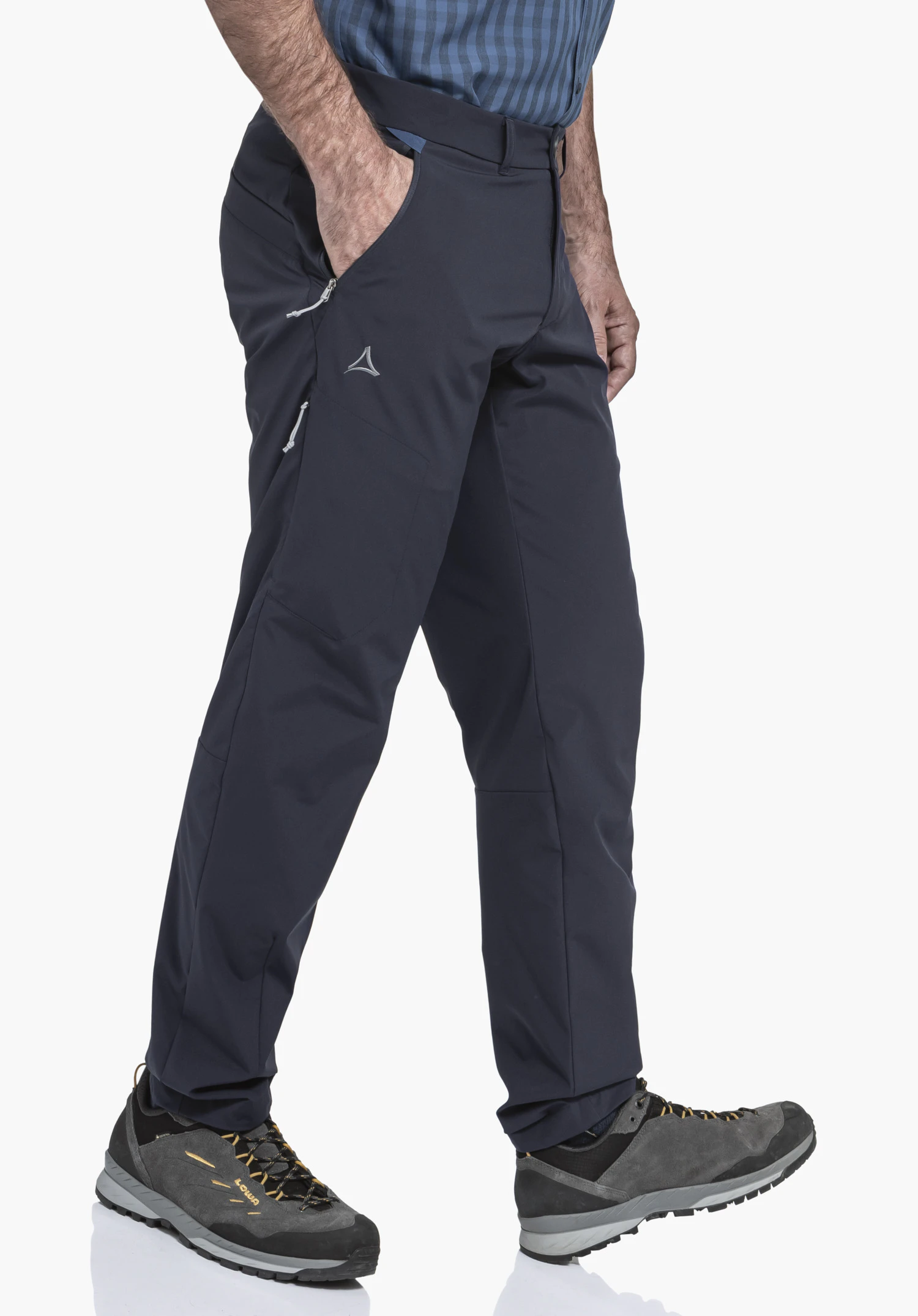 CIRC Pants Style Smue MNS in blue worn by a model standing sideways with one hand in the pocket. The Schöffel-Logo on the thigh and zipped side pockets are clearly visible, photographed against a neutral background.