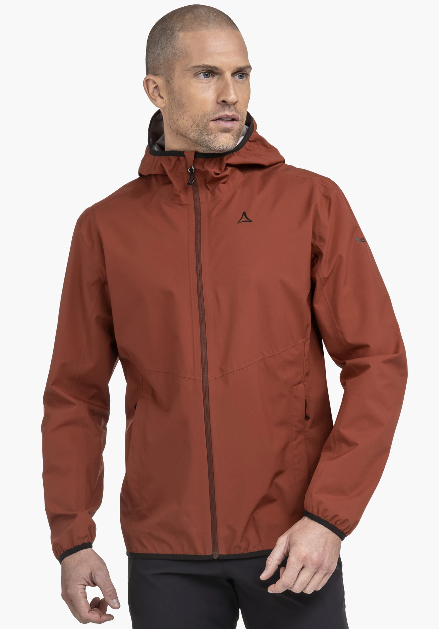 Jacket Style Migandi MNS is worn by a model in the colour red. The model stands slightly to the side and looks away, with the black Schöffel-Logo visible on the left chest, against a neutral background.