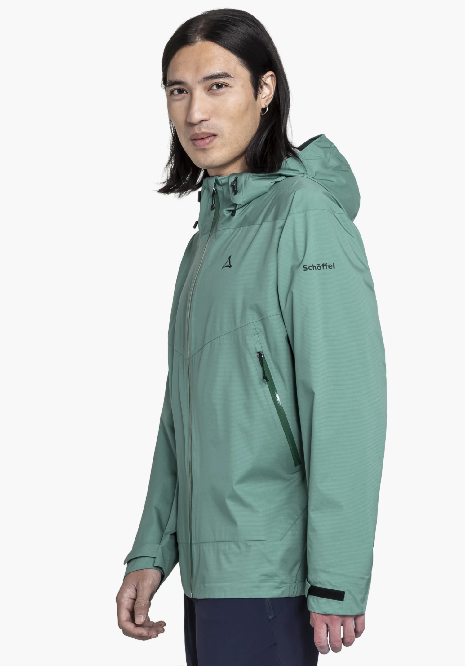 2.5L 3D Jacket Vistdal M. A model stands sideways wearing the green hooded jacket with the Schöffel logo visible on the chest and sleeve, against a neutral background.