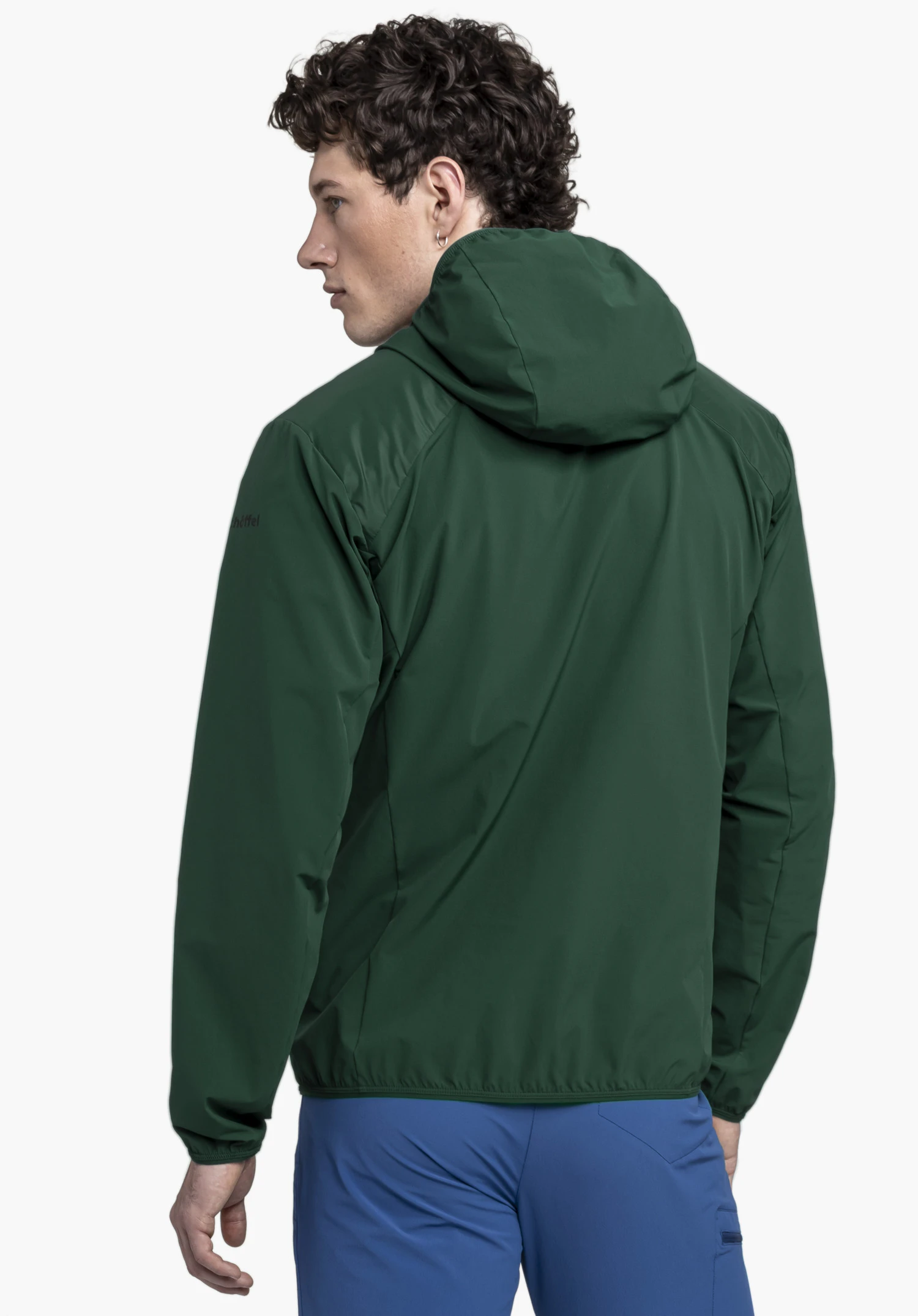 Hybrid Jk Style Blaueis MNS in the colour green, shown on a model in a back view. The back with hood and the Schöffel logo on the left sleeve are visible. The model stands in front of a neutral background.