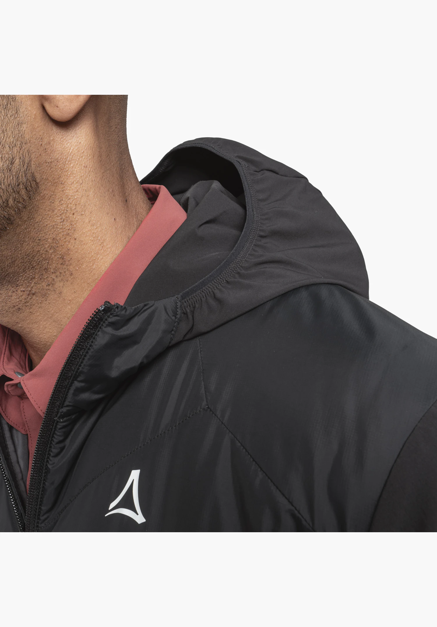 Hybrid Jk Style Blaueis MNS shows the textured black fabric section across the chest and shoulder, the partially open front zip, the elasticated edge of the hood and the white Schöffel logo. Close-up shot against a white background.