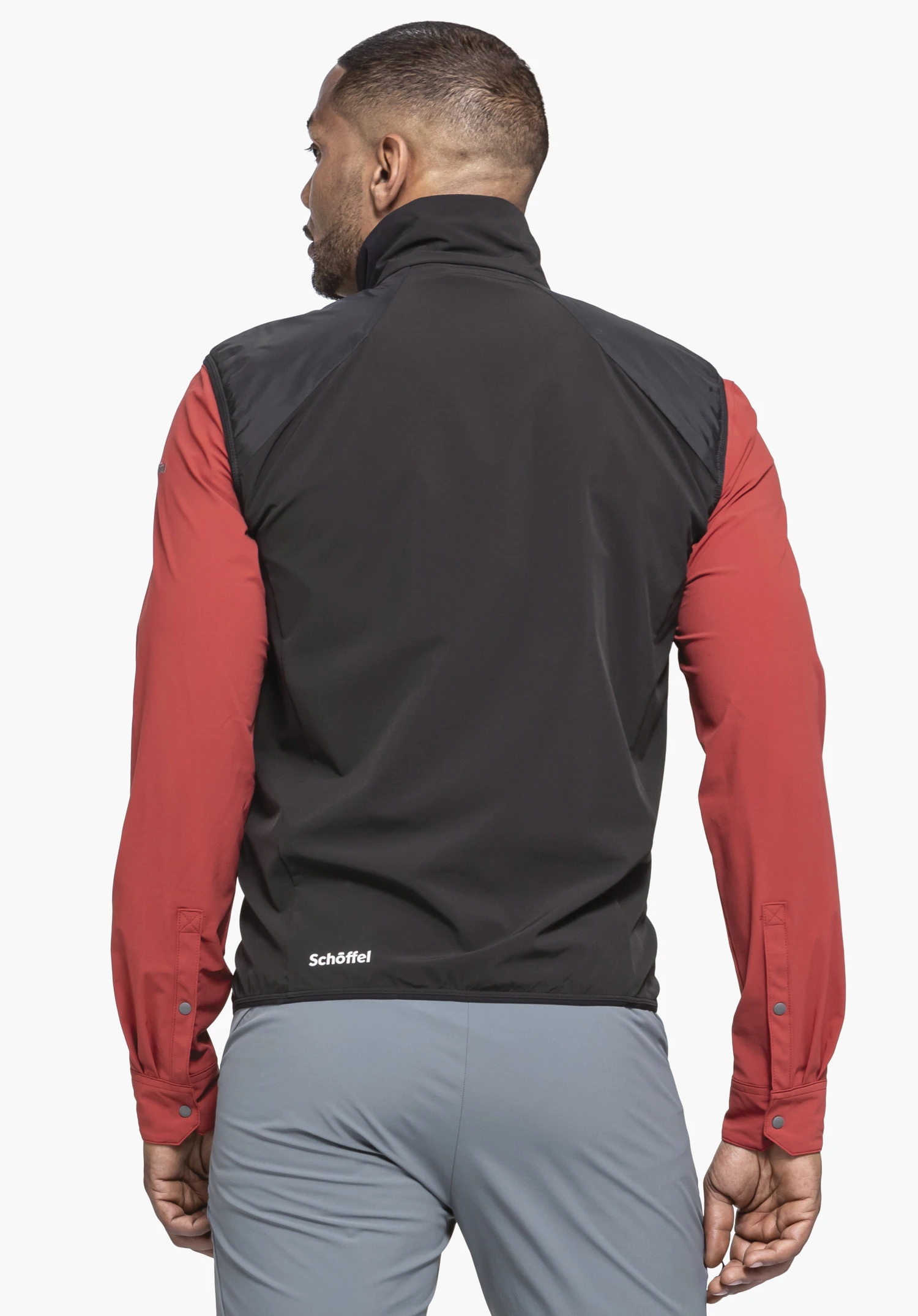 Hybrid Vt Style Blaueis MNS in the colour black, worn by a model in a back view. The white Schöffel logo is visible on the lower left back, presented against a neutral background.