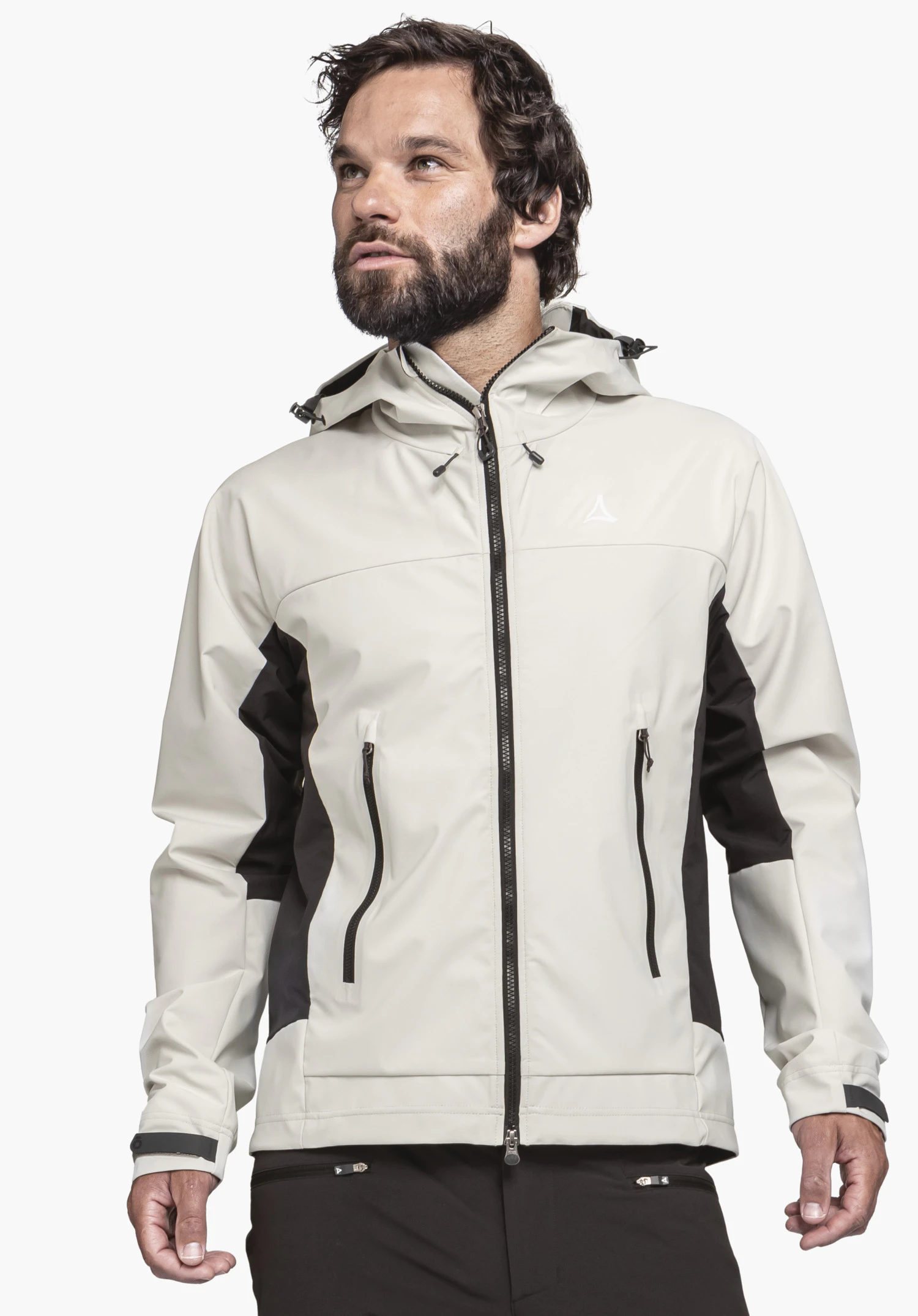 Softshell Jk Style Blaueis MNS. A male model wears the jacket in the colour natur, featuring black contrasting panels, a hood, and a closed front zip. The Schöffel logo on the left chest is clearly visible. The model stands front-facing, looking slightly to the side, against a neutral background.