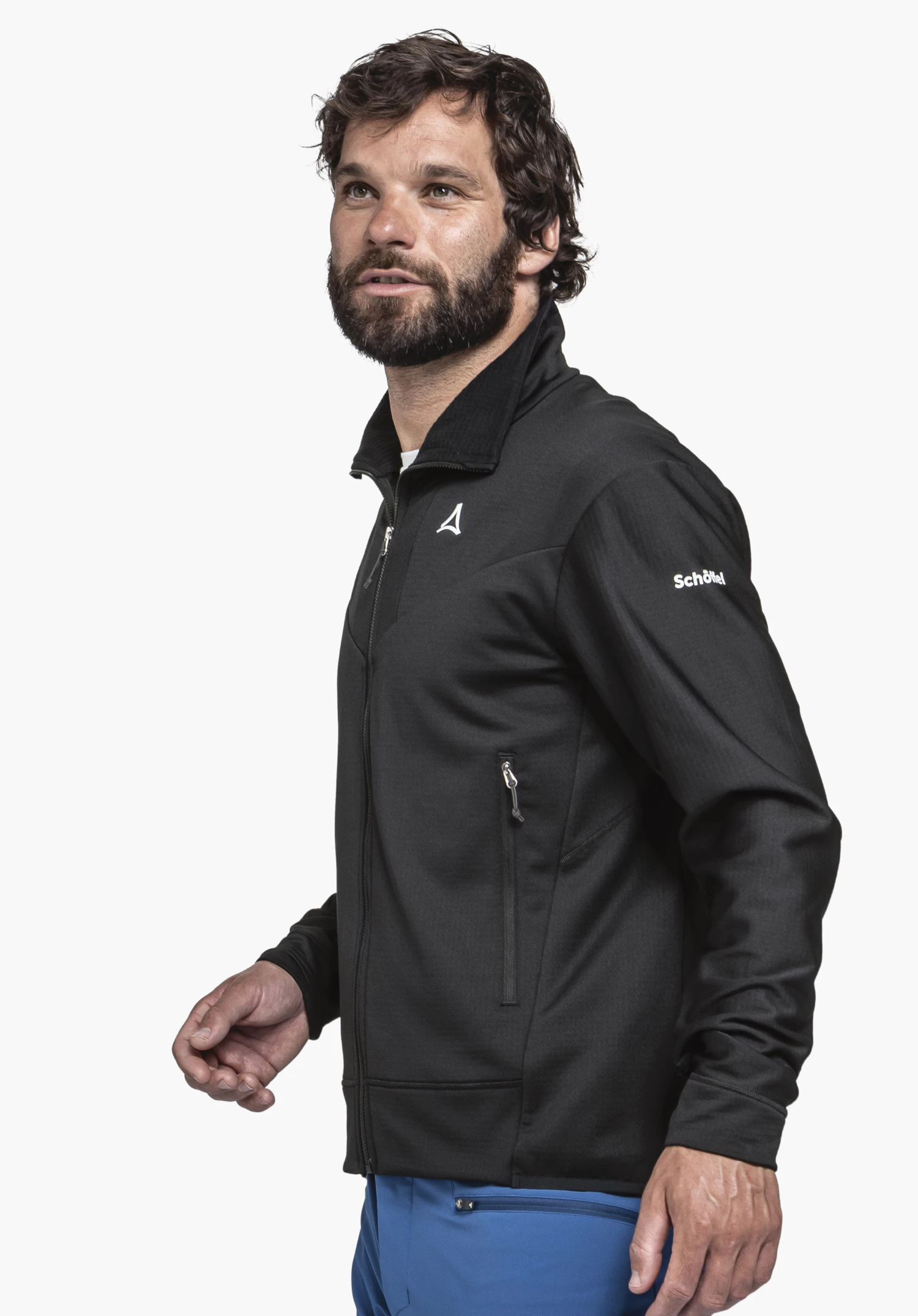 Fleece Jkt Style Blaueis MNS in classic black. The model is captured in a side profile view against a neutral background. The shot highlights the quality texture and the prominent Schöffel logo on the upper arm.