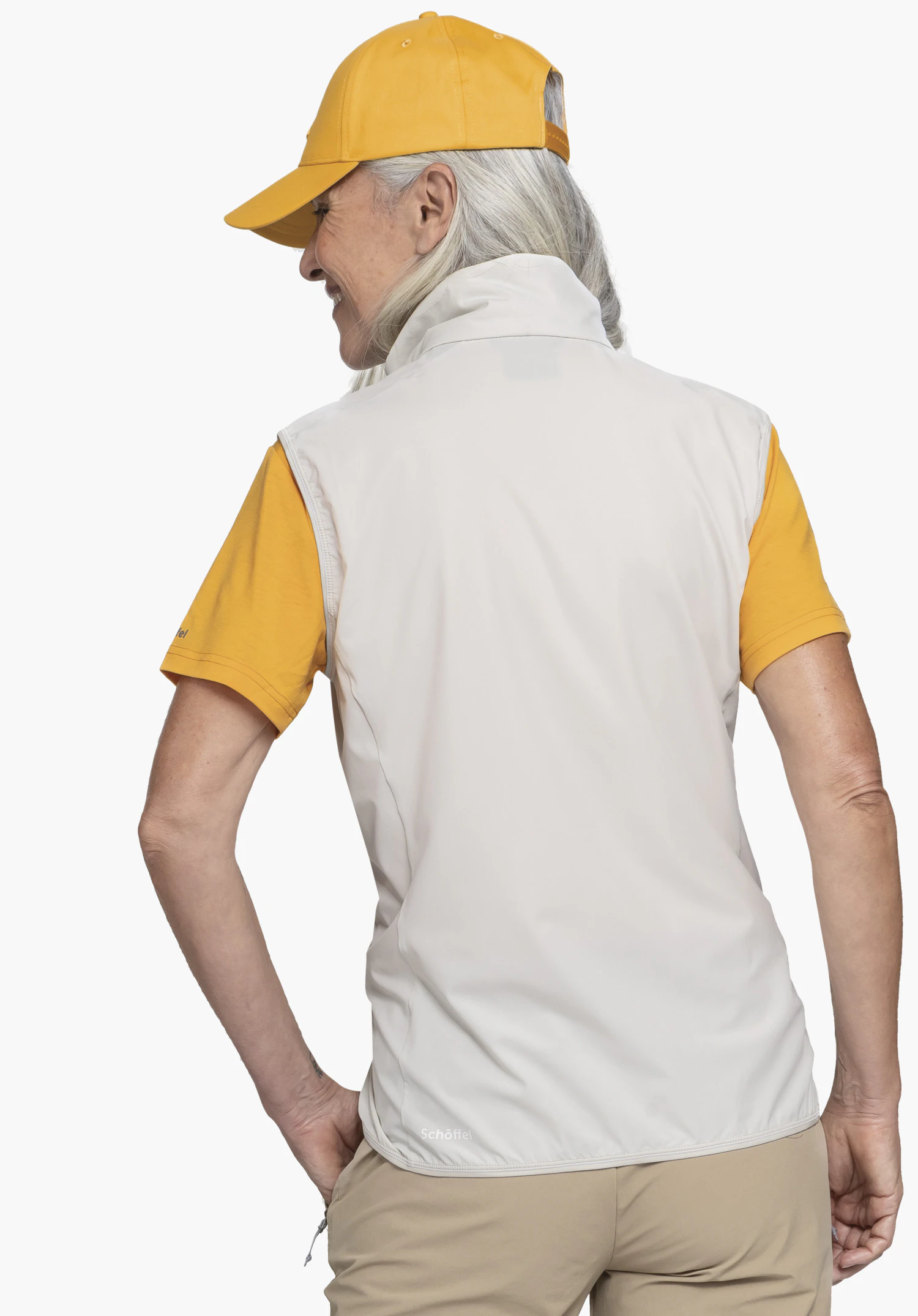 Hybrid Vt Style Blaueis WMS de couleur natur, vue de dos portée par un mannequin sur un fond neutre, avec le logo Schöffel visible sur l'ourlet inférieur.
