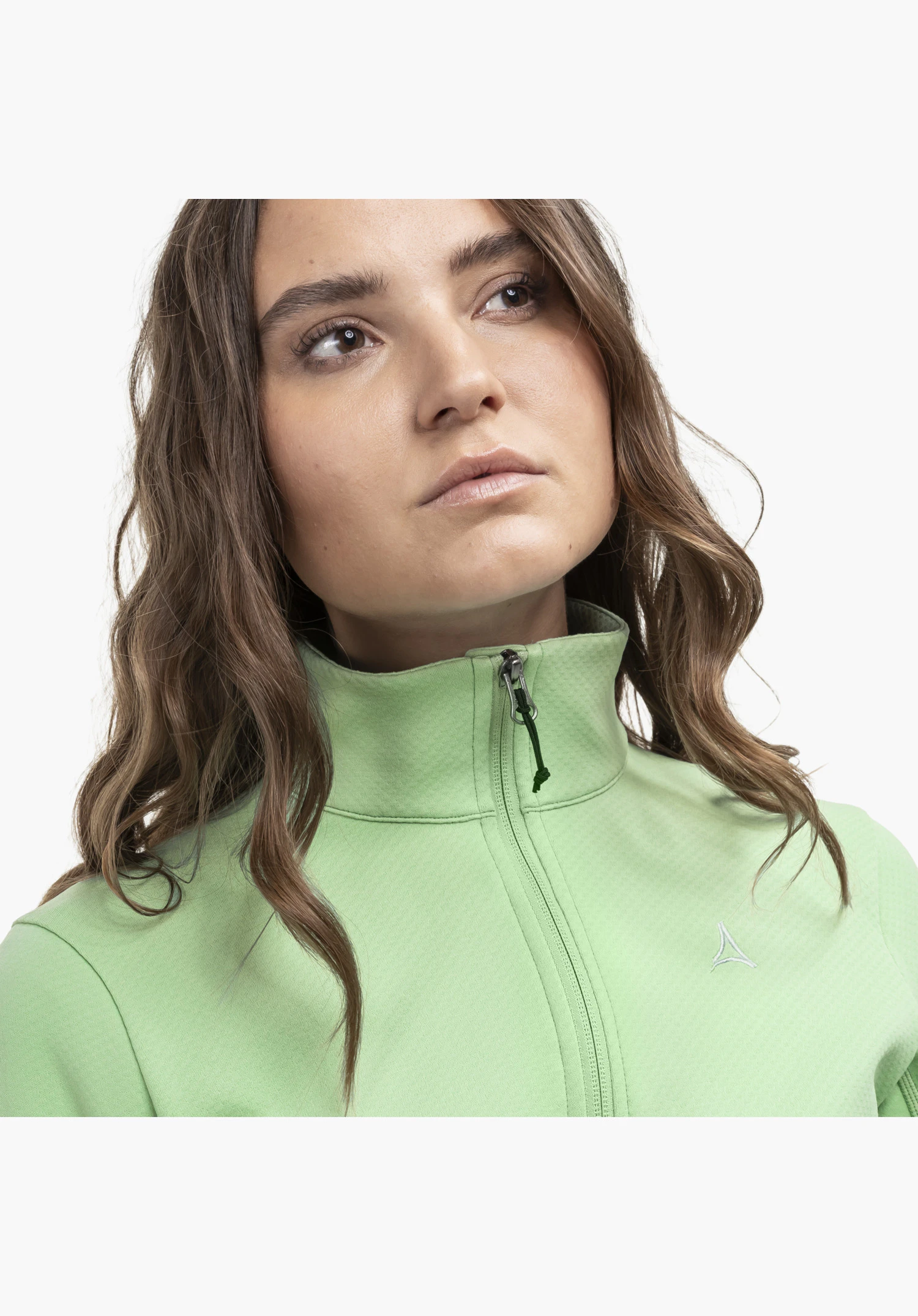 Fleece Jk Style Uriezzo WMS, the high-closing collar in green featuring a functional zip and the subtle Schöffel logo on the chest, close-up against a white/neutral background.