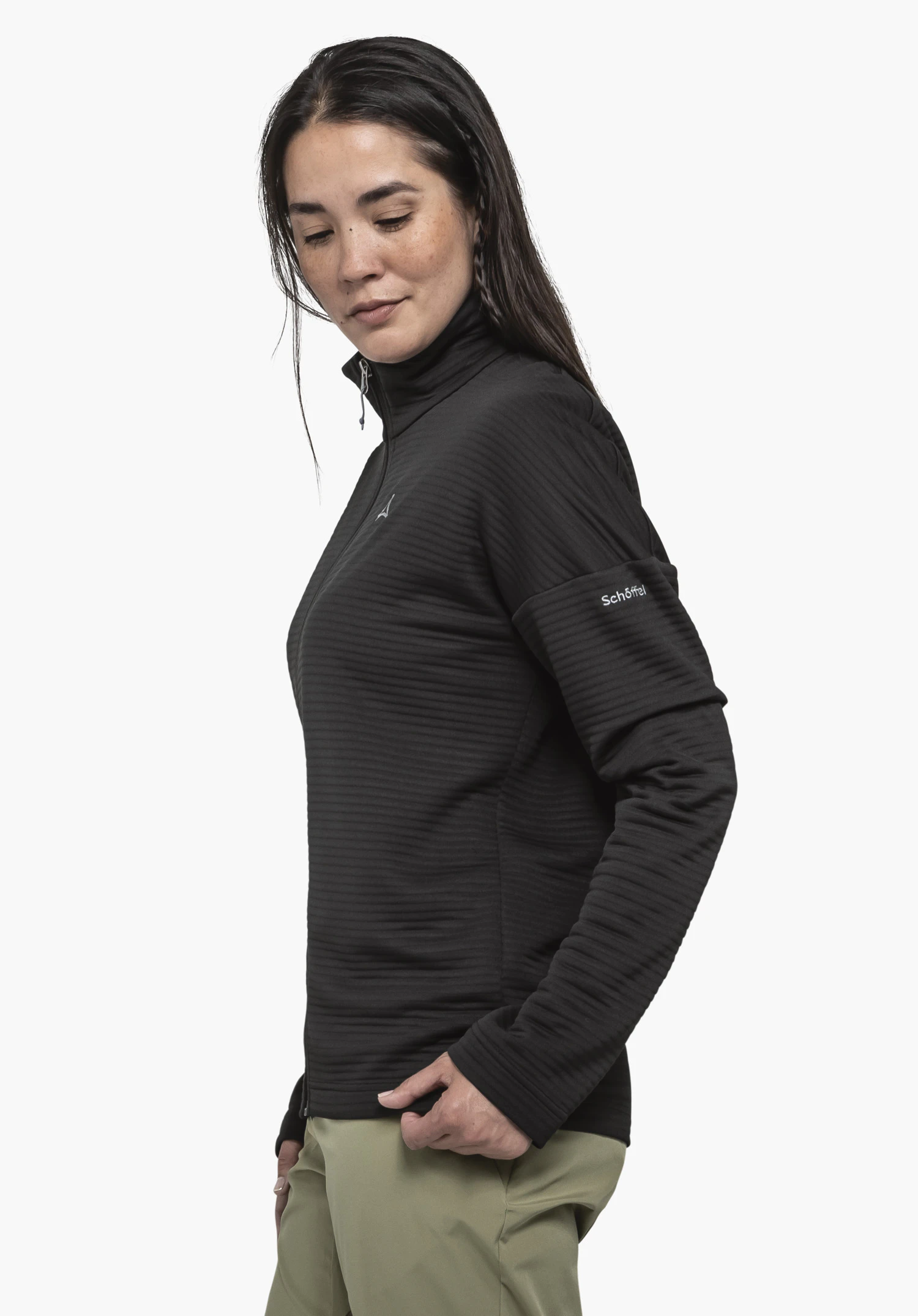 CIRC Fleece Jk Style Smue WMS in black. A model stands in a side profile view against a neutral background, showcasing the fleece jacket featuring the Schöffel logo on the sleeve.