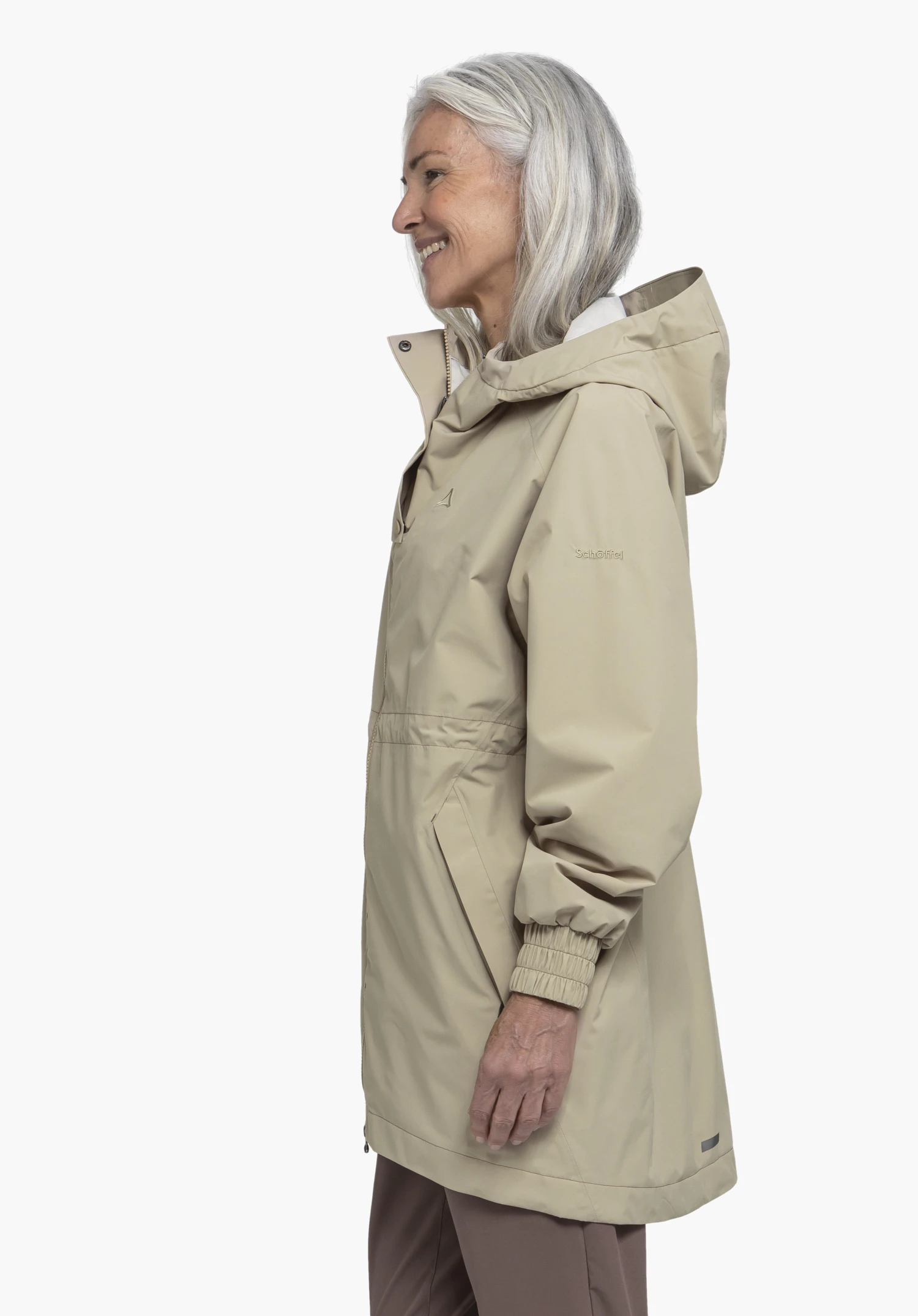 Parka Style Bohorok WMS in beige on a model standing sideways. The jacket is presented against a neutral background. The Schöffel-Logo is clearly visible on the sleeve.