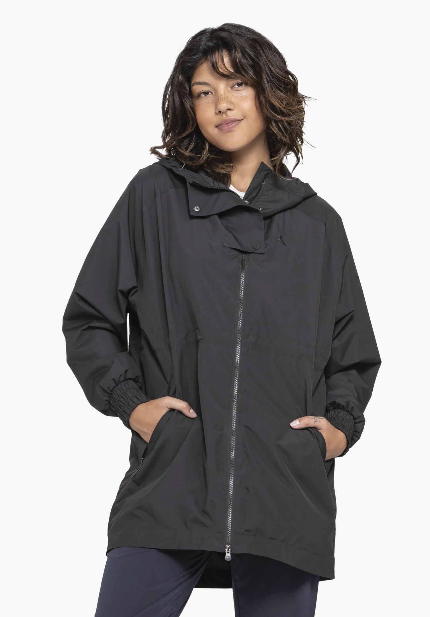 Parka Style Bohorok WMS in black. The front view shows a model in a relaxed pose with their hands casually in the pockets. Set against a neutral background, the subtle Schöffel logo is clearly visible on the chest.