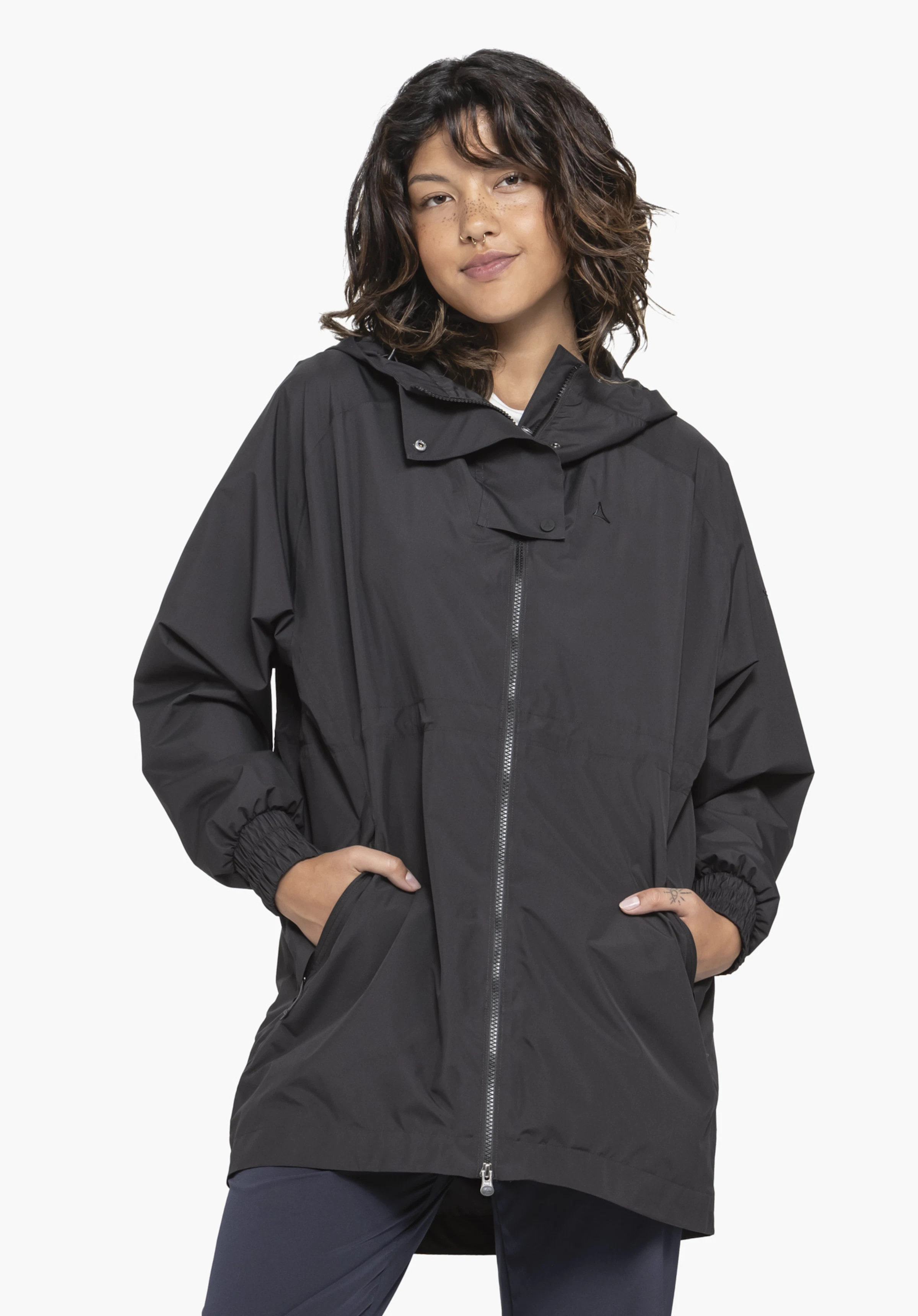 Parka Style Bohorok WMS in black. The front view shows a model in a relaxed pose with their hands casually in the pockets. Set against a neutral background, the subtle Schöffel logo is clearly visible on the chest.