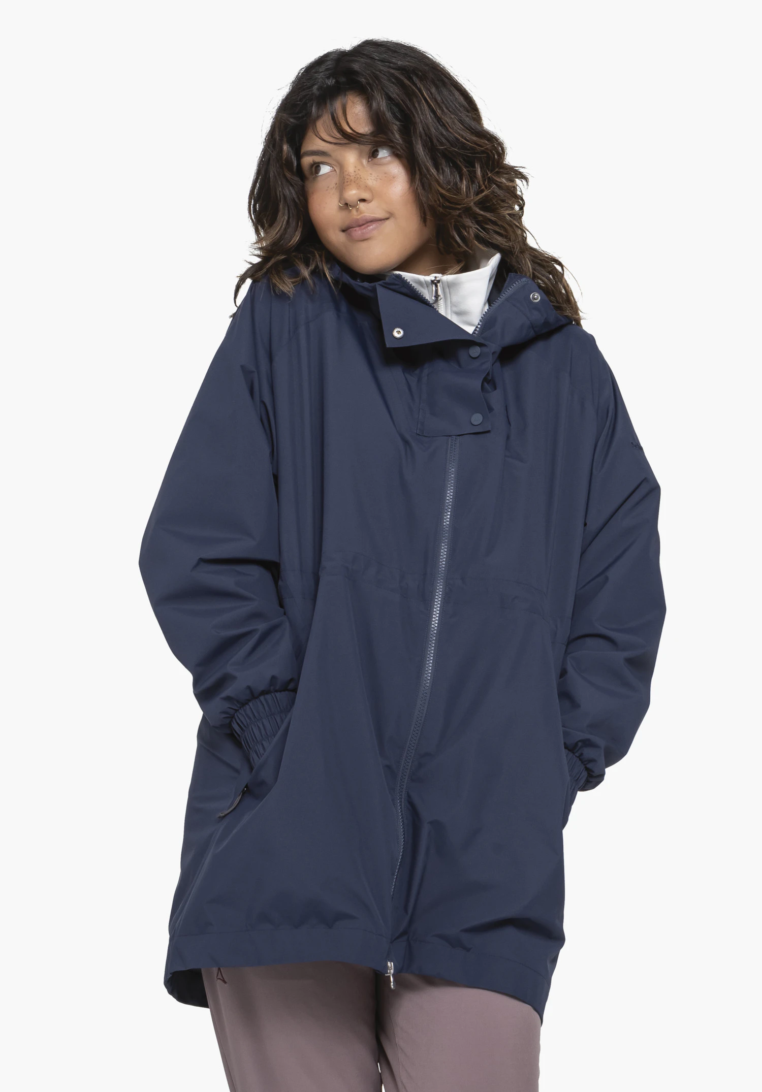 Parka Style Bohorok WMS in blue. The model is standing in a slightly angled pose and looking to the side against a neutral background. The jacket is zipped up, and the subtle Schöffel logo is visible on the upper arm.