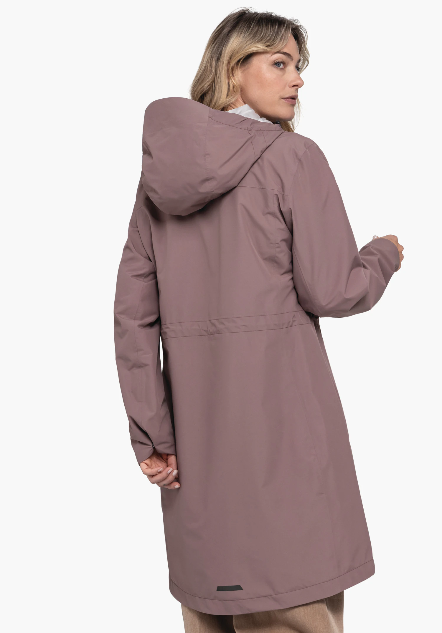 Coat Style Bohorok WMS worn by a model in a back view. The brown hooded coat is shown from behind as the woman looks over her right shoulder, standing against a neutral background.