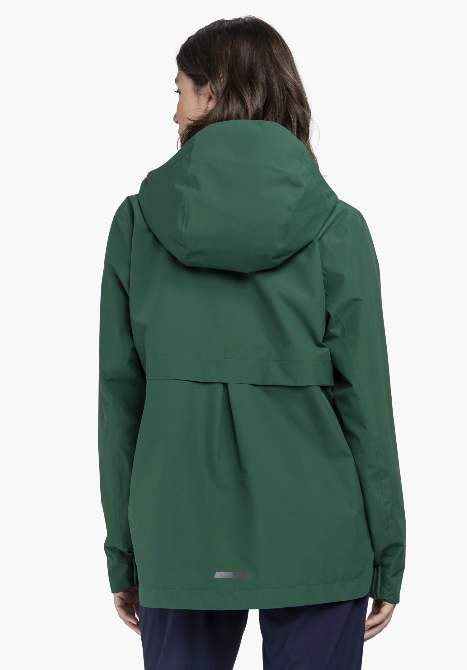 Jacket Style Bohorok WMS worn by a model in a back view. The green jacket features an attached hood as well as a striking pleat detail in the middle of the back. The model stands in front of a neutral background.
